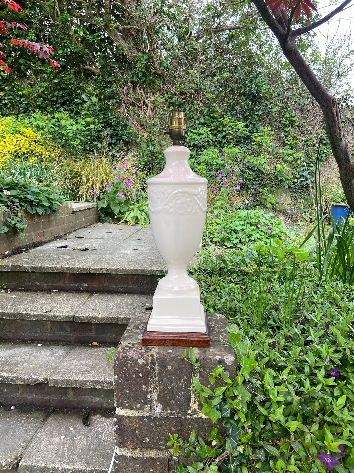 cream ceramic lamp on wooden base