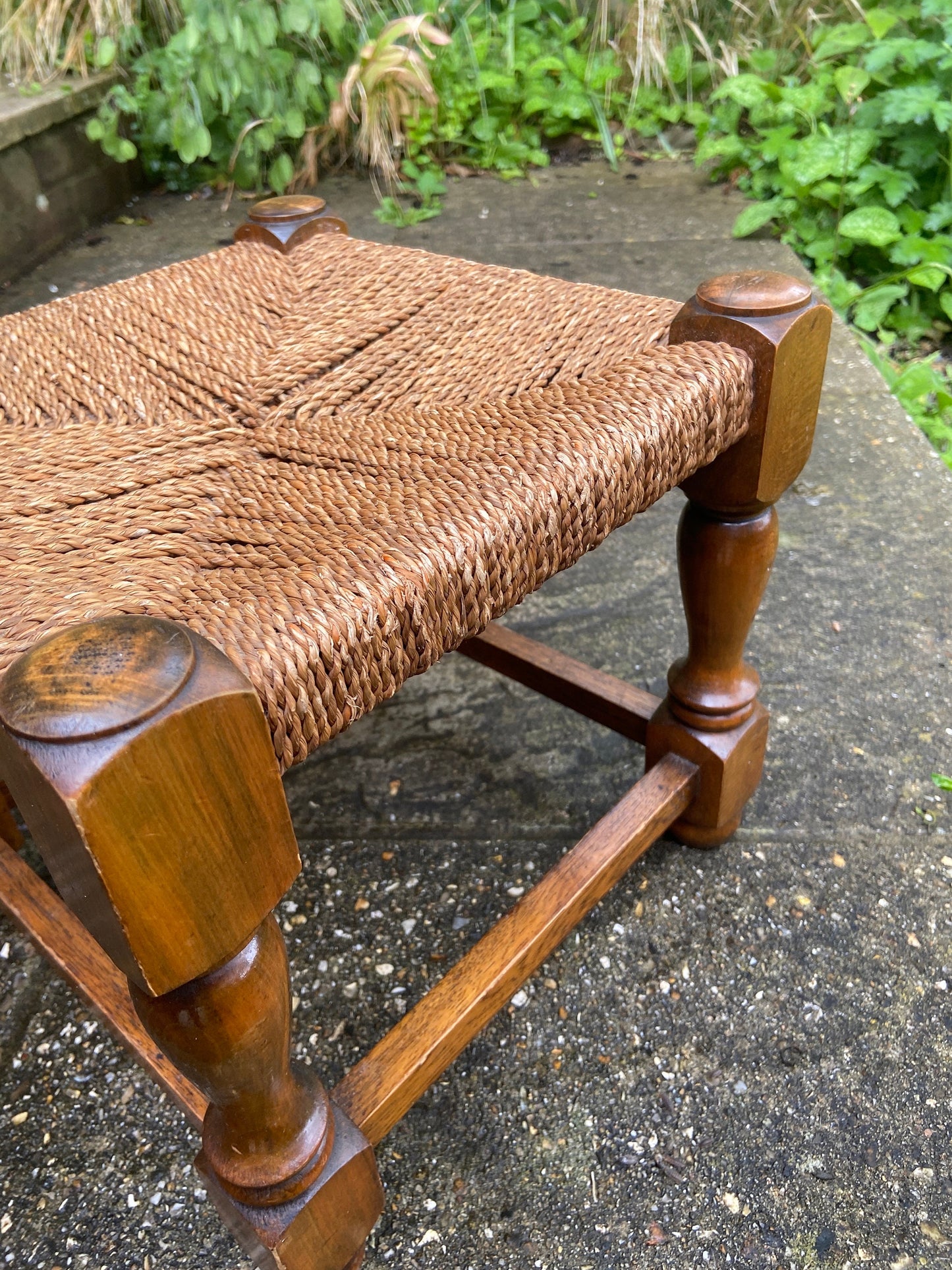 Early twentieth century vintage foot stool, wooden frame with string woven seat, authentic old stool, child stool