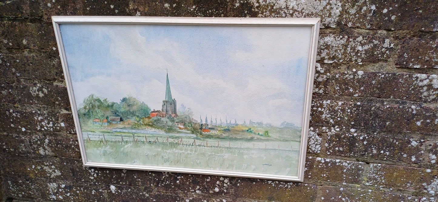 retro watercolour painting of a Kent townscape, landscape. water colour of a kent scene. church and houses along a riverbank or meadow. Painted by artist Stringer. Framed in white retro wooden frame, with glass