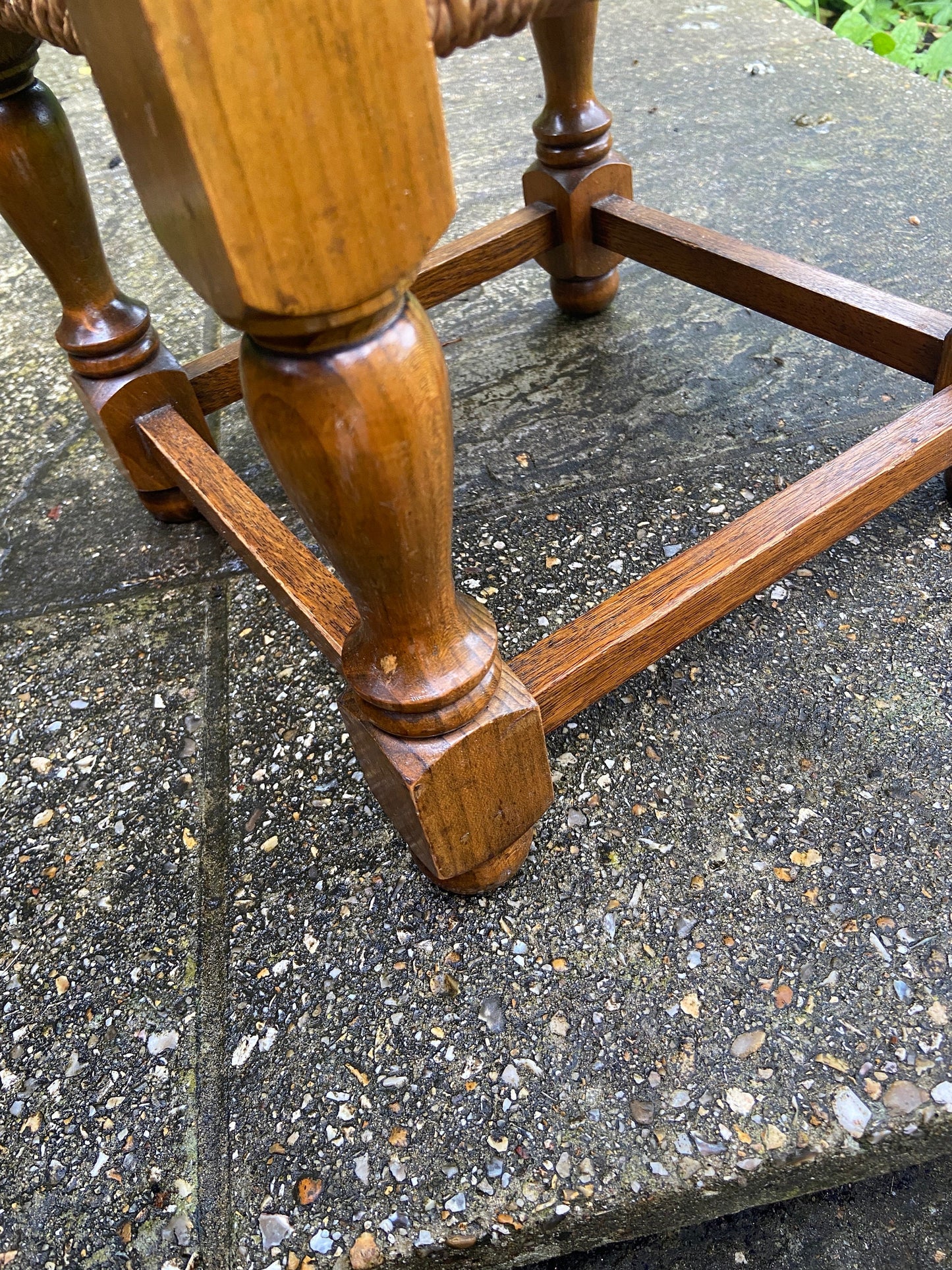Early twentieth century vintage foot stool, wooden frame with string woven seat, authentic old stool, child stool