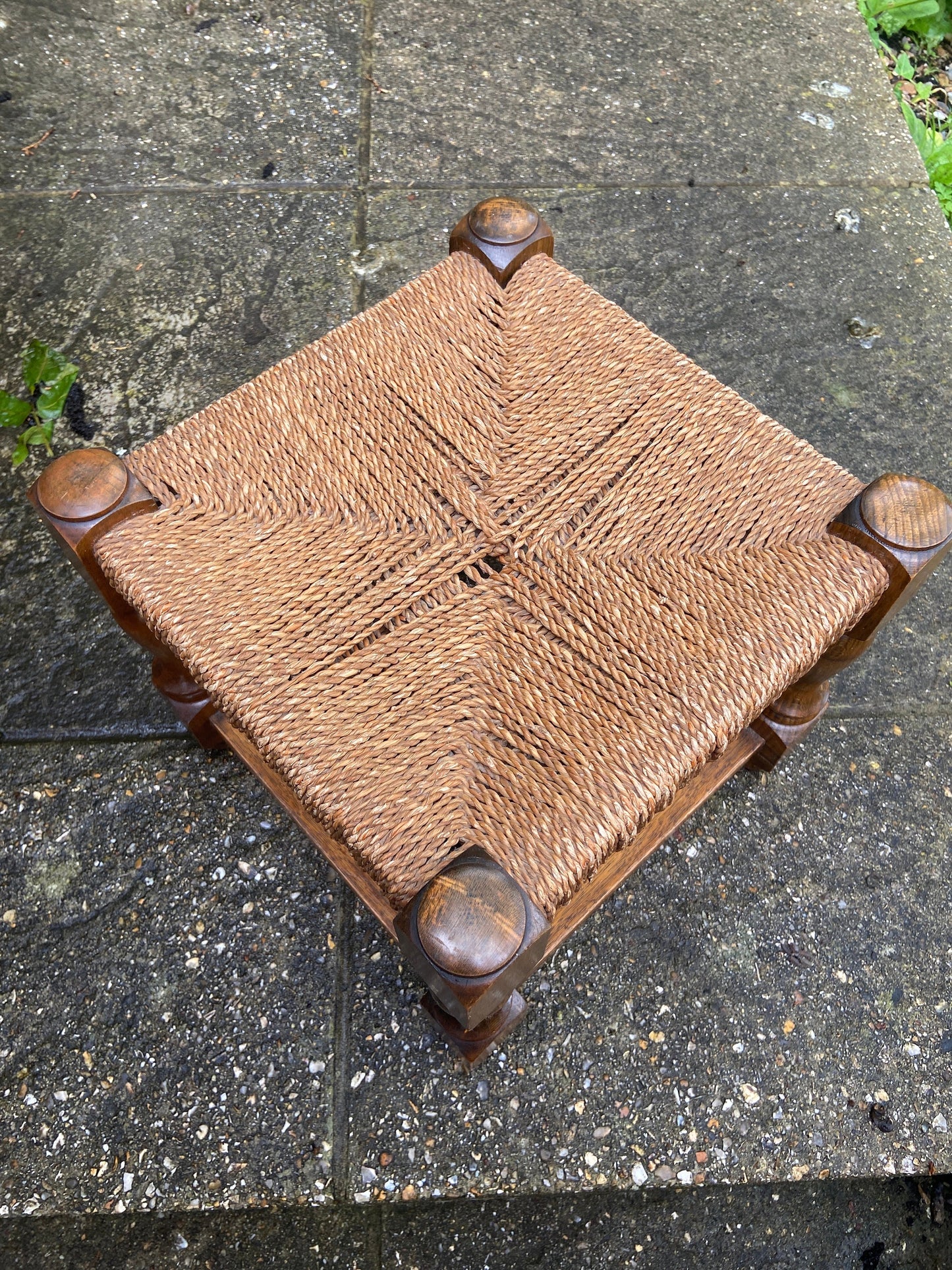 Early twentieth century vintage foot stool, wooden frame with string woven seat, authentic old stool, child stool
