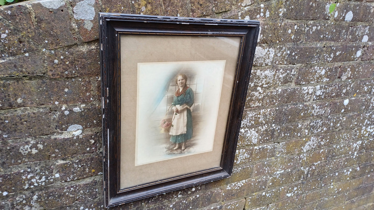 Vintage photo sepia of young woman, in dark wood vintage glazed frame