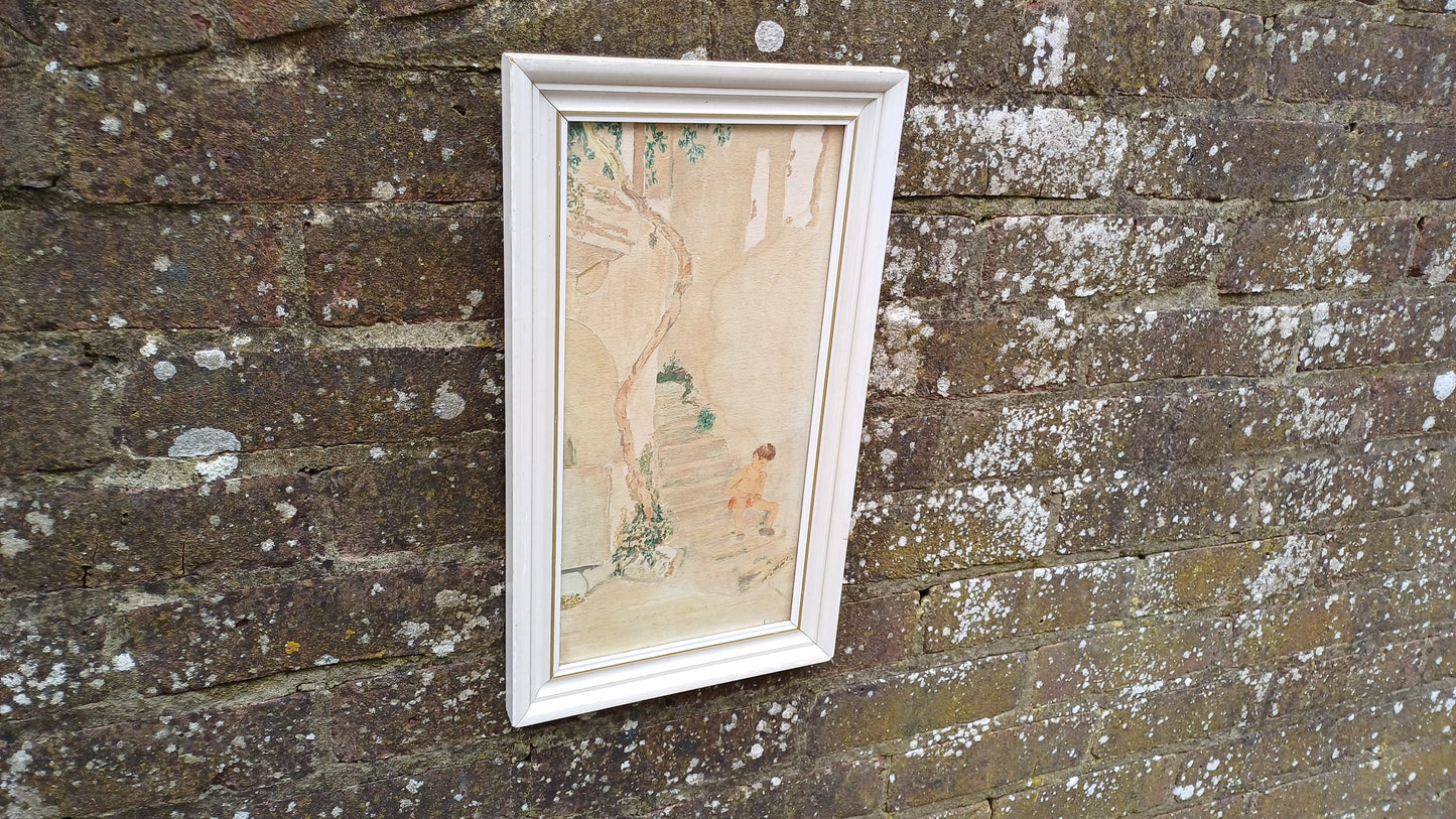 Vintage watercolour of a Mediterranean Village scene, boy on steps enjoying hot weather. Small vertical painting in glazed retro frame.