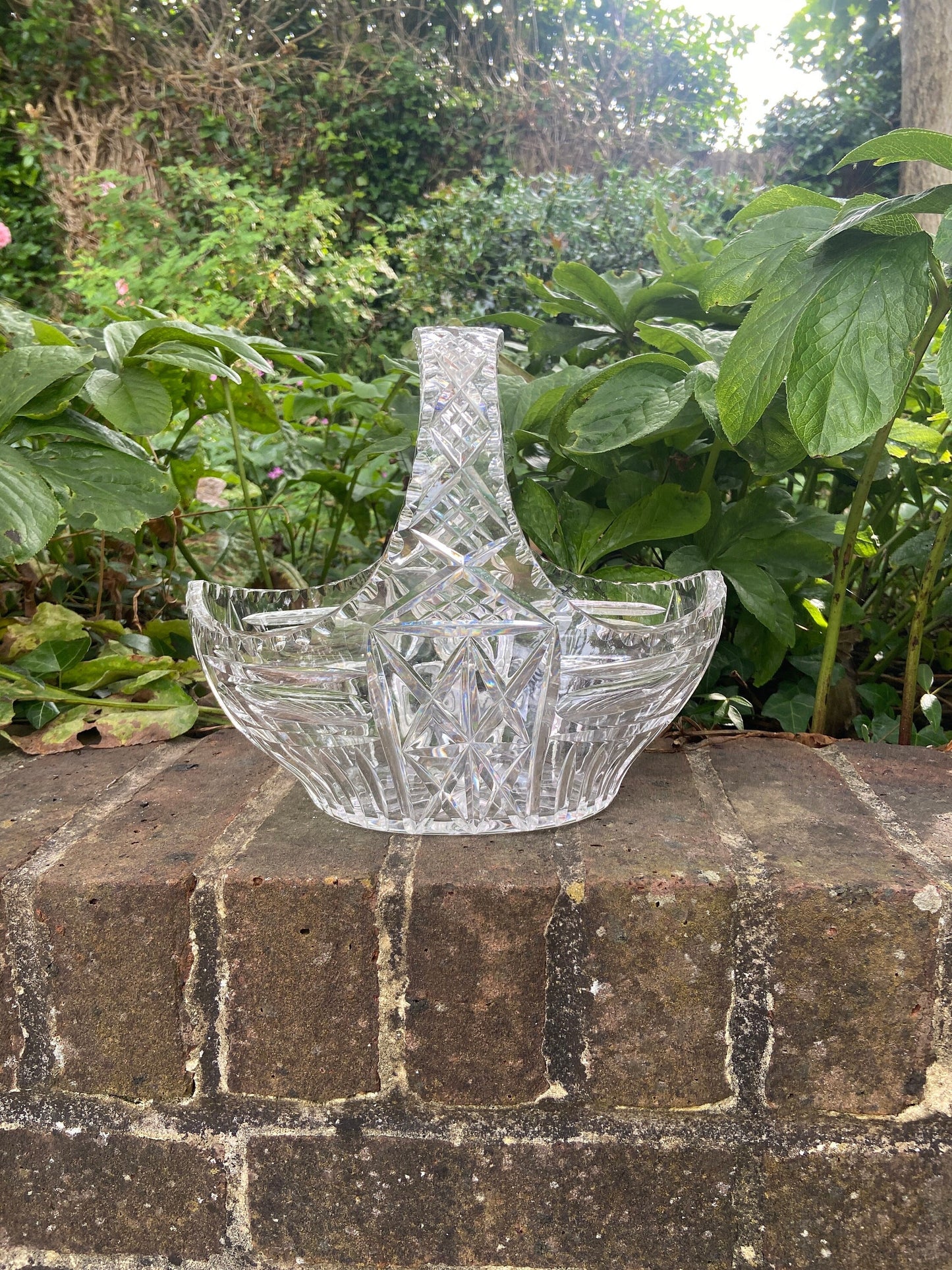 crystal glassbowl. shaped like a basket. great for displaying fruit, flowers, pebbles etc. excellent quality with the glass catching the light. excellent condition