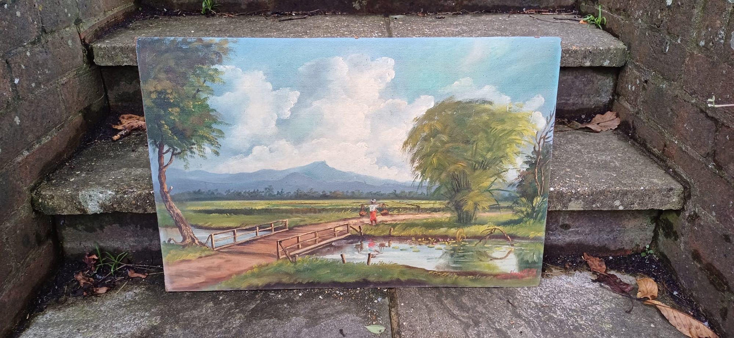 1960s oil on board by artist Yusoff Abdullah. Rural scene of a villager / farmer carrying goods across a field. Signed painting