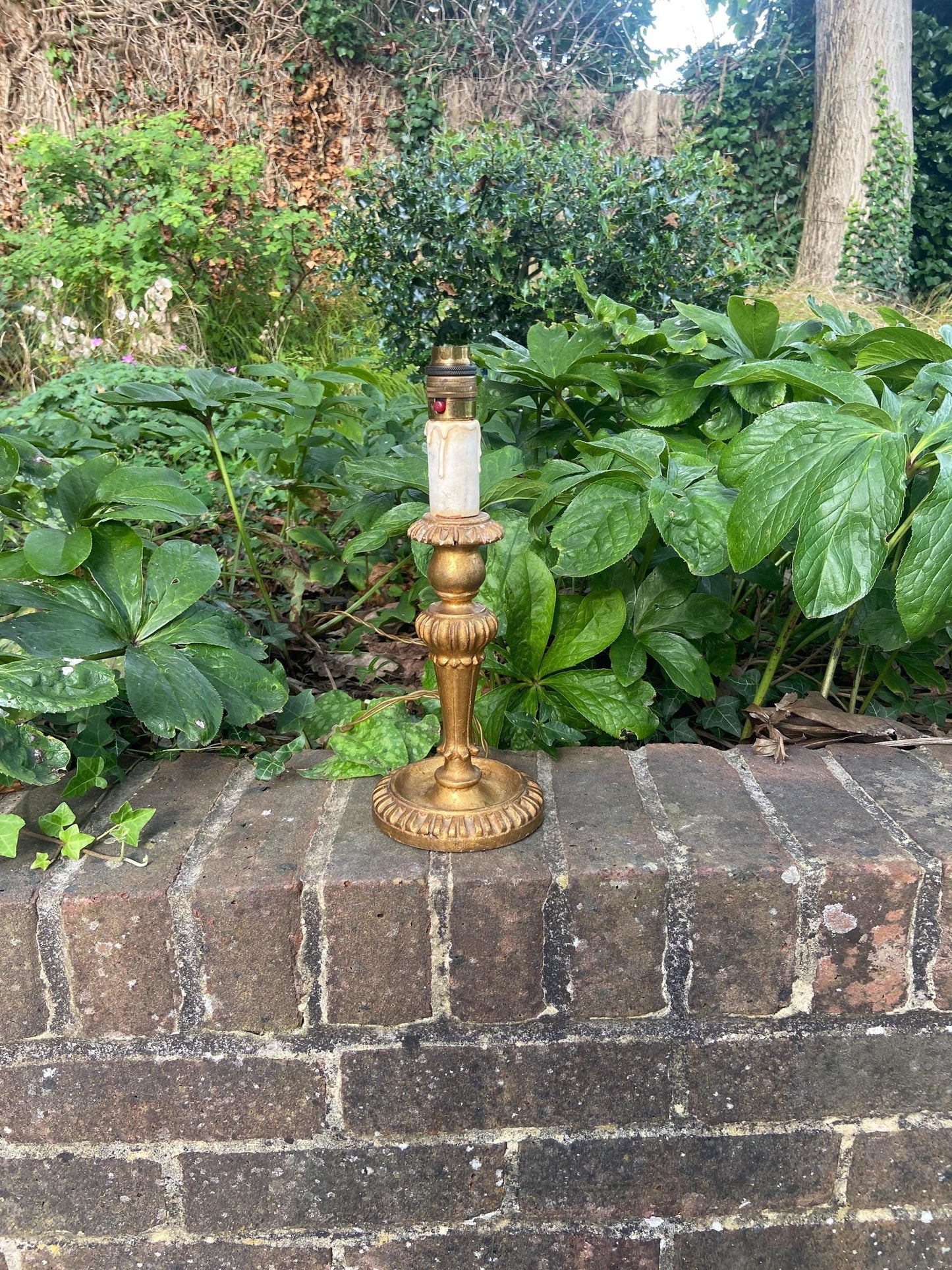 mid century retro table lamp in candlestick design. made out of a very light wood and then painted ina gold paint. lovely original version of this style lamp. working condition