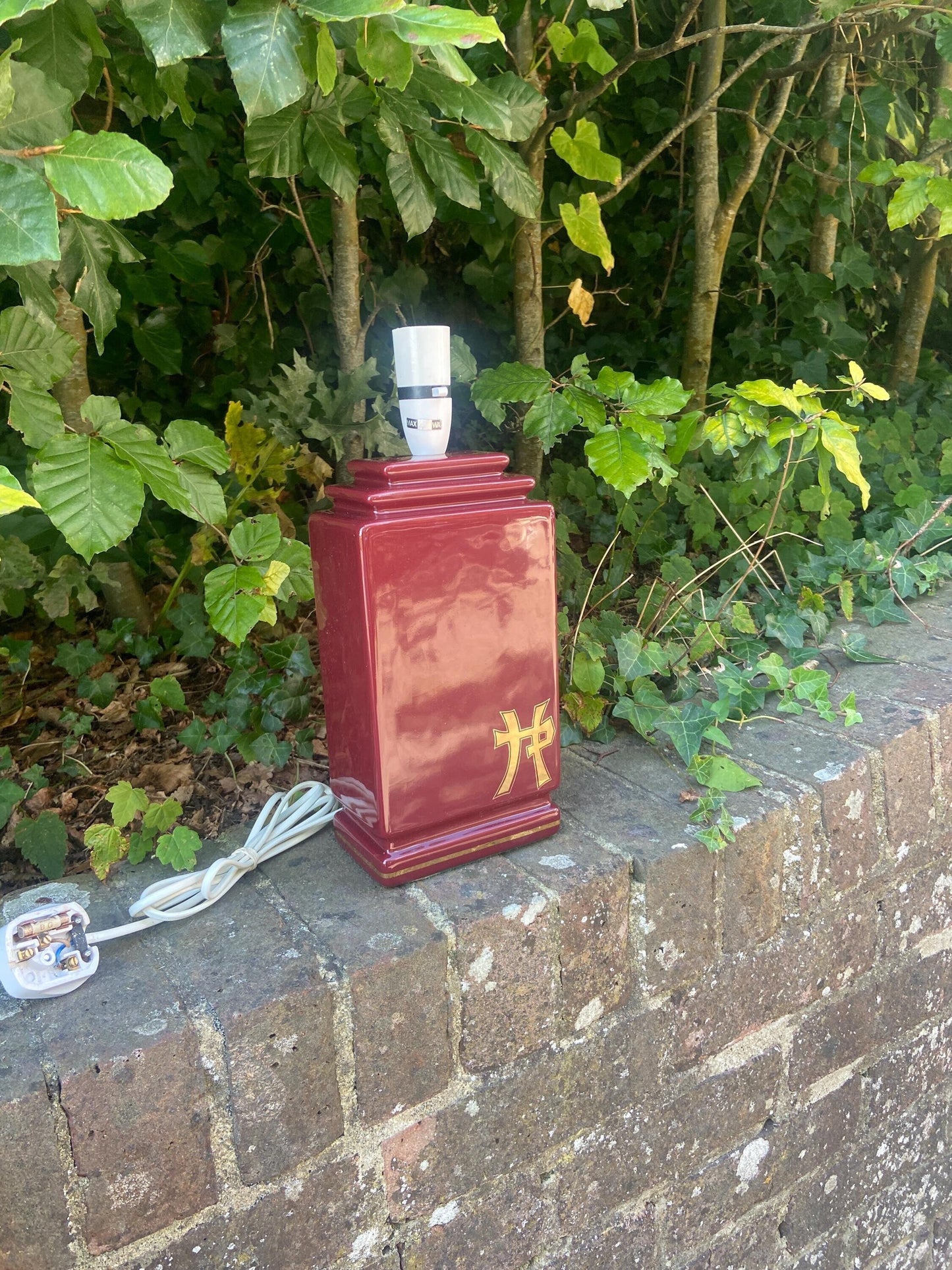 deep wine red, burgundy, rectangularshaped vintage table lamp. red and gold. Has Chinese / Asian lettering or symbol on it. Very attractive and quite unusual shape and style. working order.