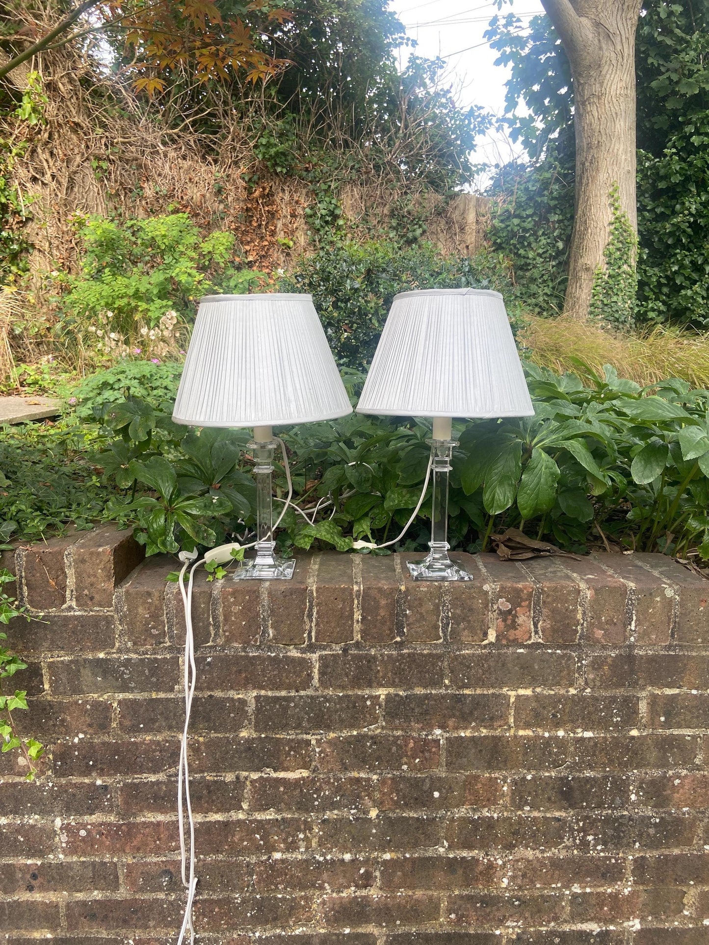 vintage glass column lamp bases,a pair of lamps made out of glass with pleasted light grey laura ashley shades