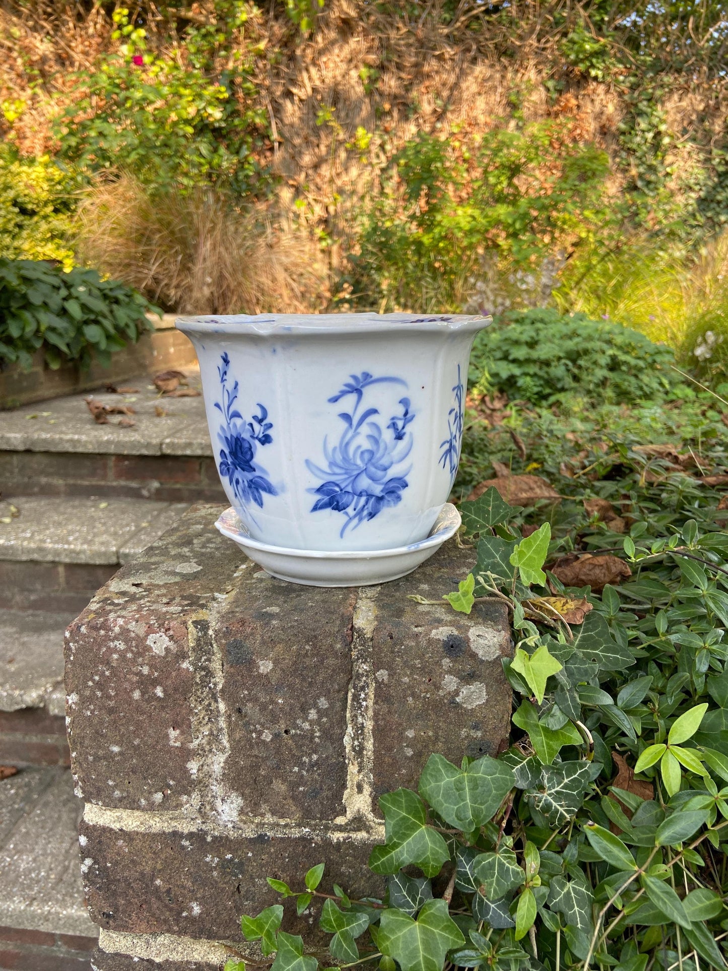 vintage and or antique planter, plant pot. made out of china, ceramic. white with hand painted blue decoration. comes wiht matching blue and white saucer. functional and pretty. good condition.