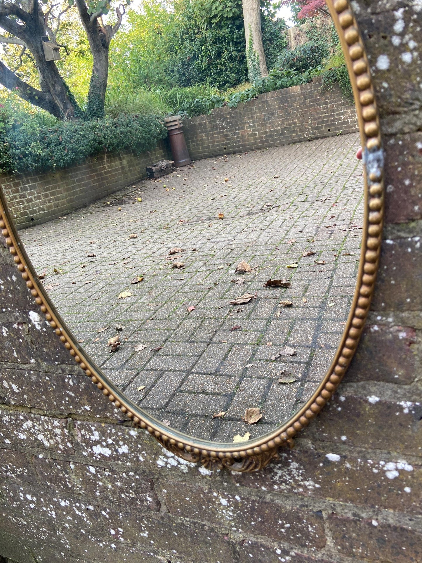 Delightful ornate vintage gilt metal framed oval mirror
