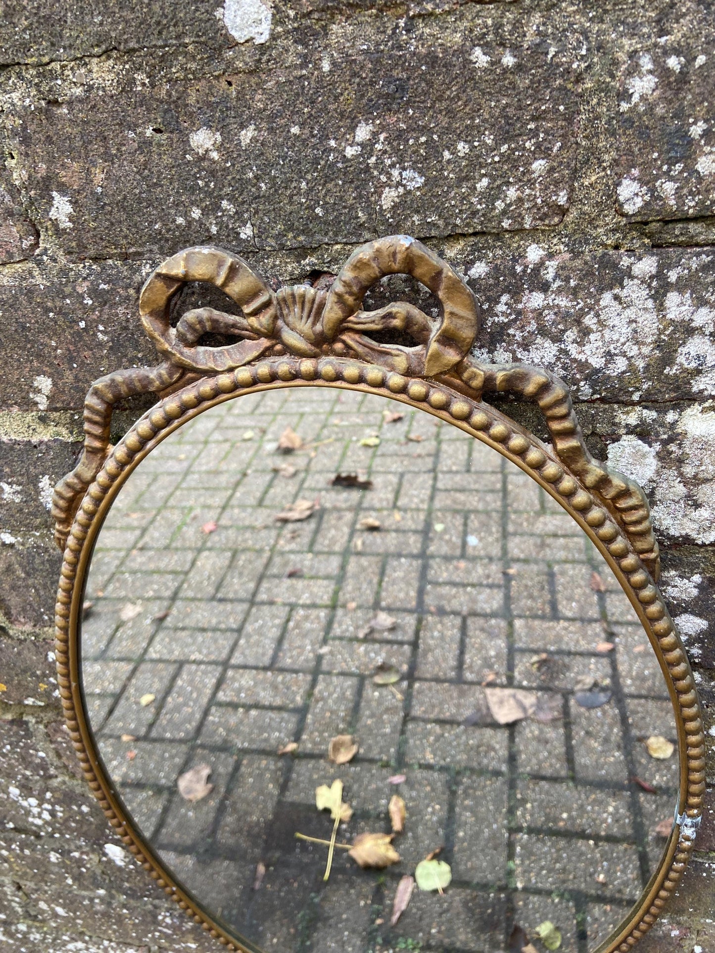 Delightful ornate vintage gilt metal framed oval mirror