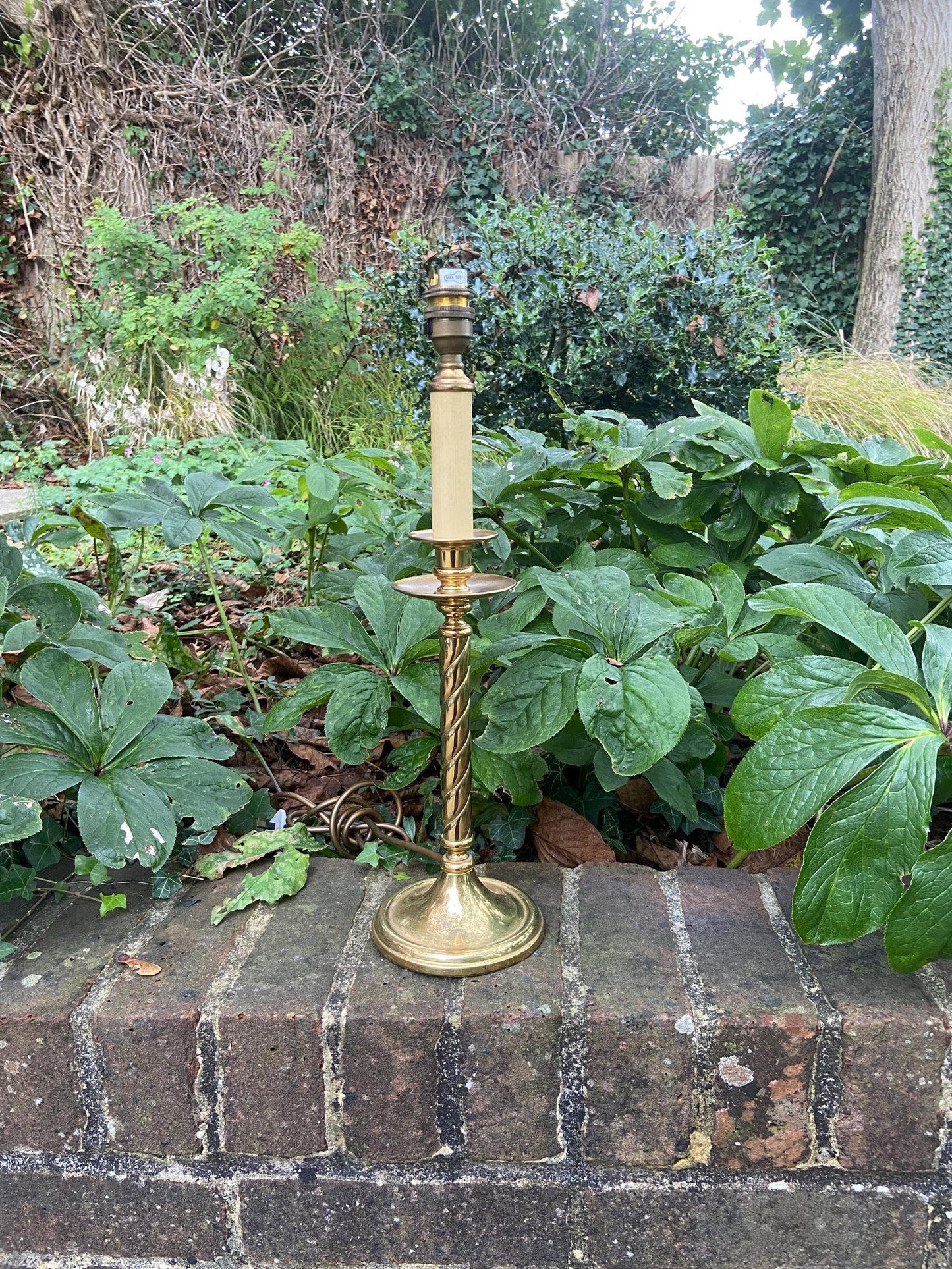 quality brass vintage table lamp. made in england. heavy good quality. candlestick design with ribbon detail on the stem. working vintage light and lamp
