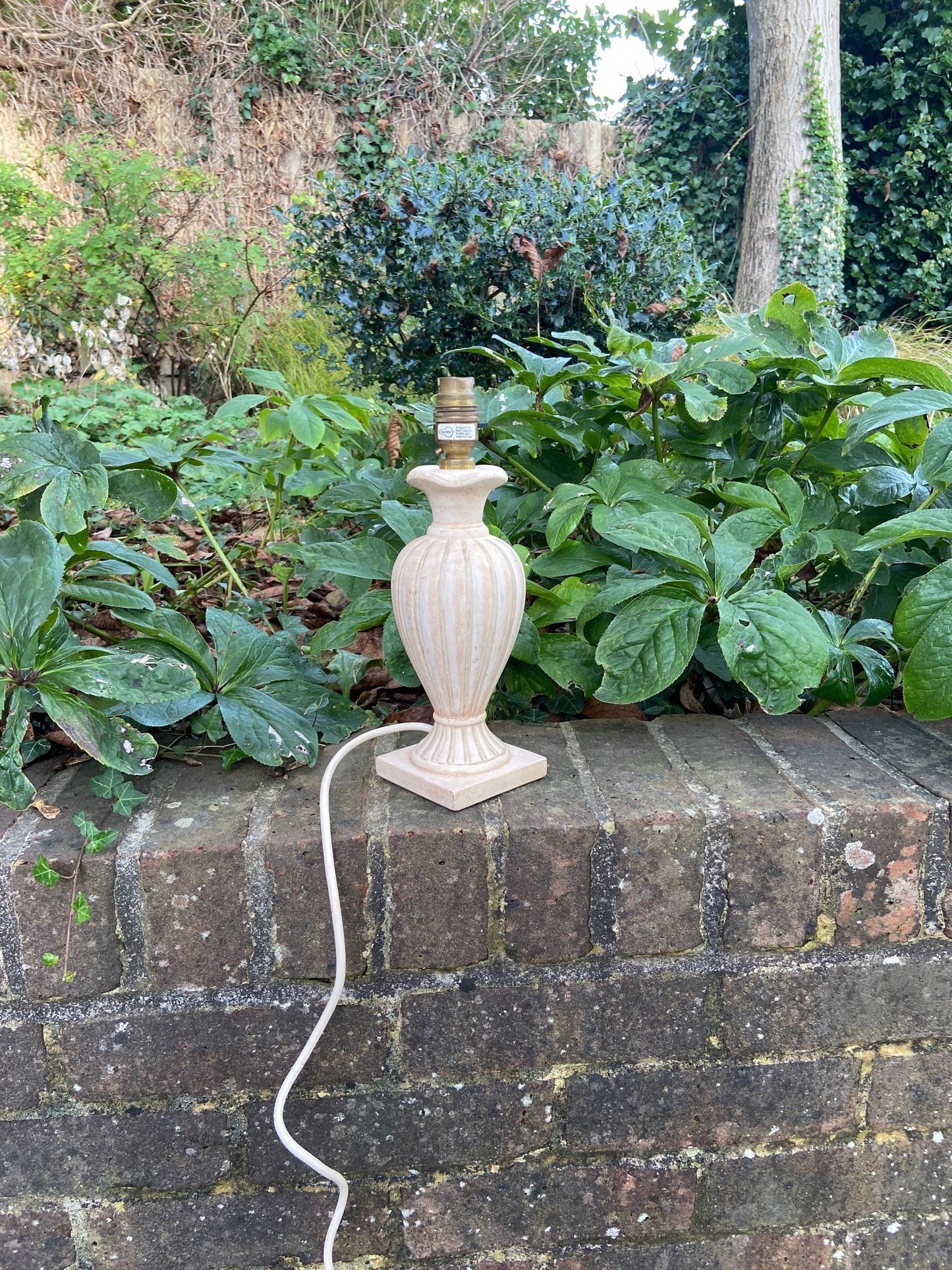 ceramic urn style lamp. classic shape. cream and other neutral hues. working table lamp