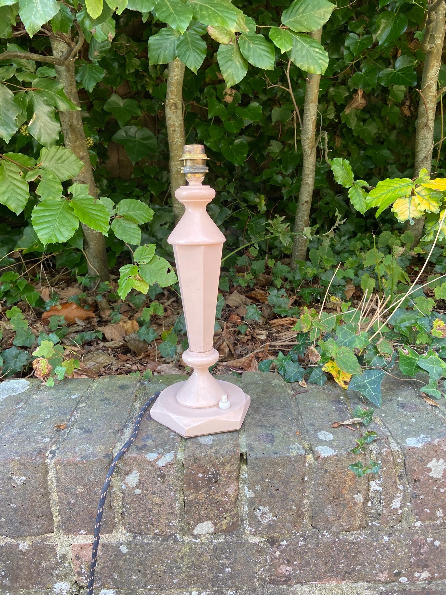 painted pink vintage table lamp. likely mid century. wooden. lovely shape. original wiring and plug.