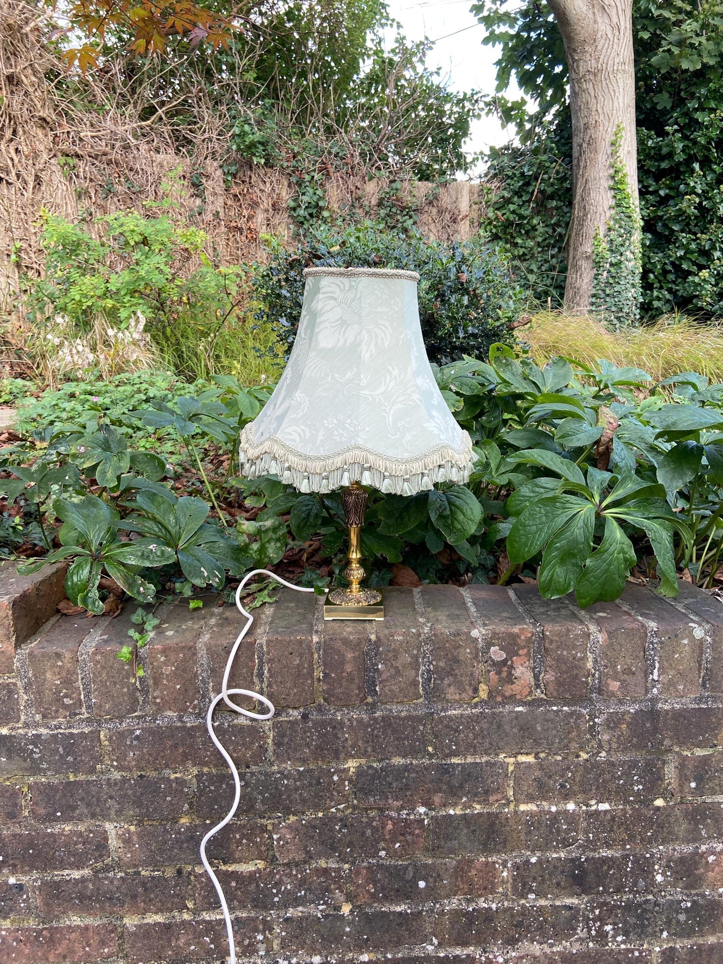 ornate brass vintage table lamp on a square base. comes with an authentic Empire style light green lamp shade. working lamp shade
