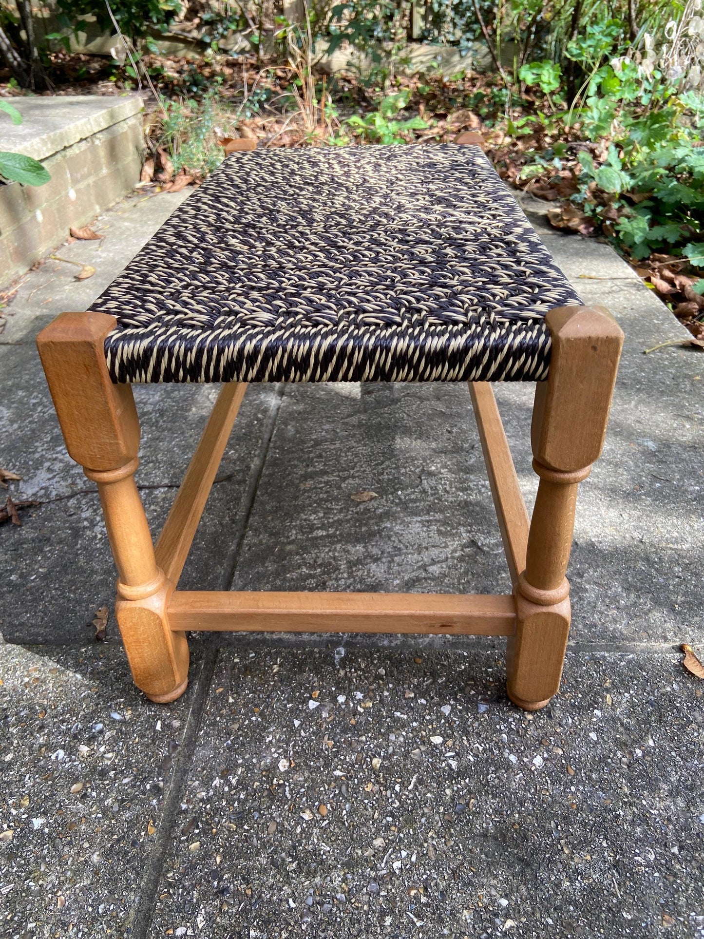 Retro strung string stool – excellent condition, black and white plastic string criss-cross on light coloured wooden frame