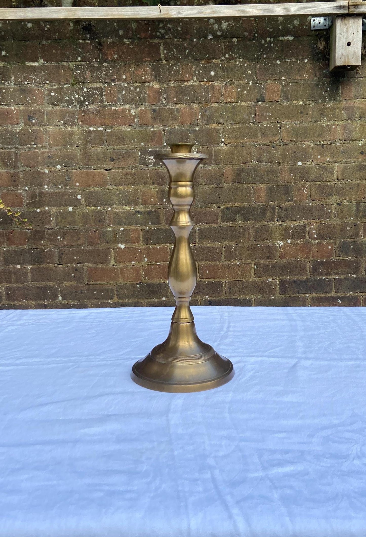 lovely tall candlestick holder made out of solid Indian brass. excellent condition. quality holder