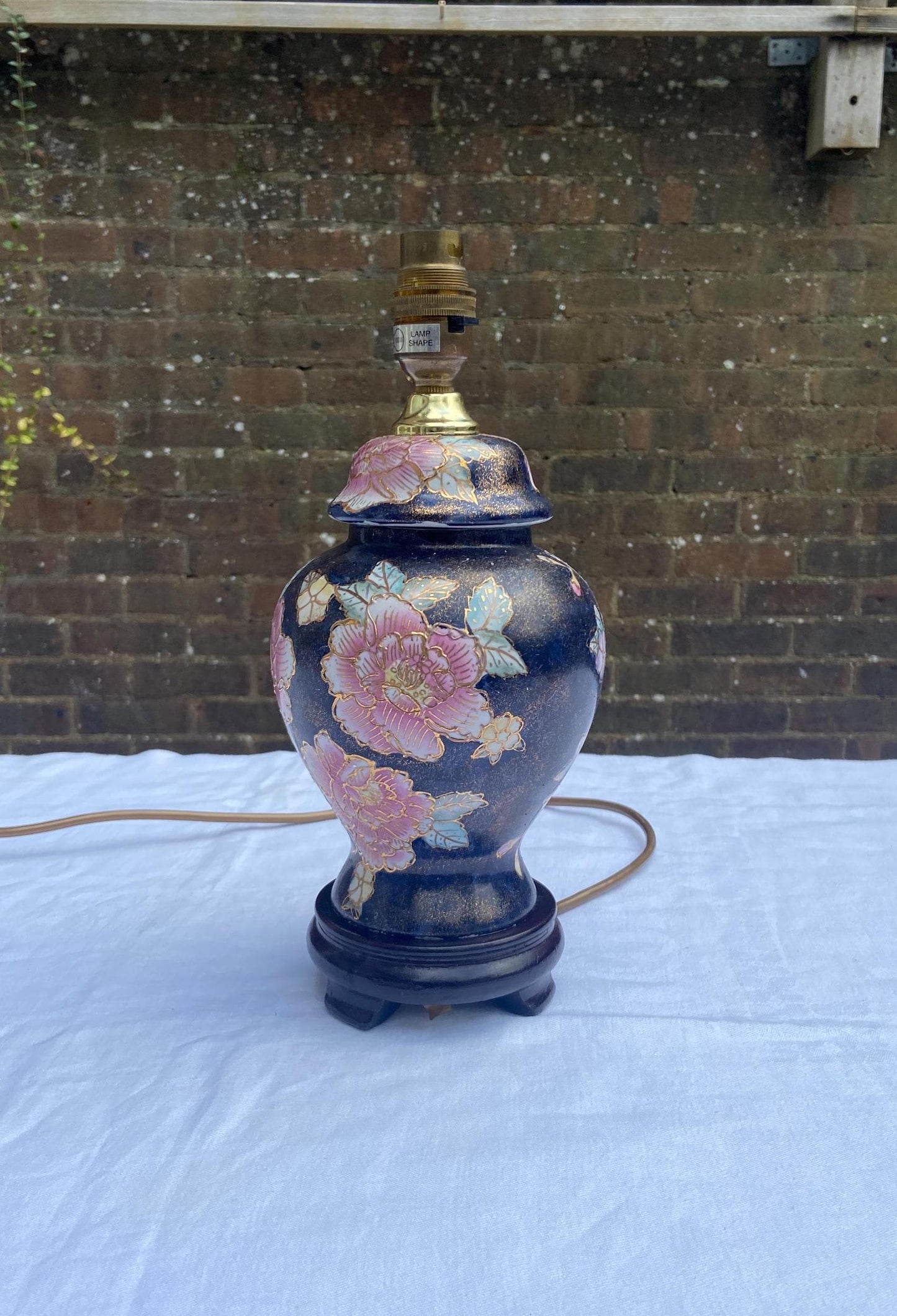 unusual colouring for a oriental style lamp. navy with gold specks. bright pink flowers with light blue too. working ginger jar lamp