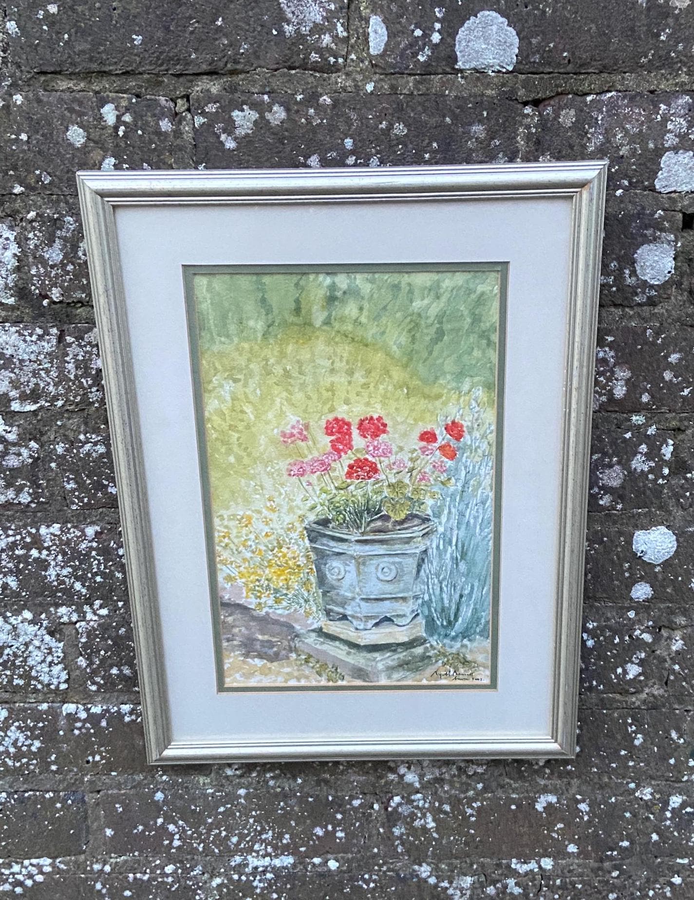 original watercolour painting of geraniums in a stone urn. summer flowers. bassett