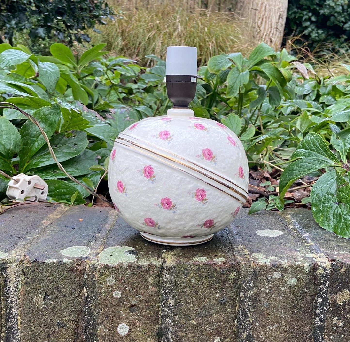 pretty mid century ceramic lamp. round lamp with roses on it, a crackle glaze,and a gold horizontal band around the lamp. original wiring
