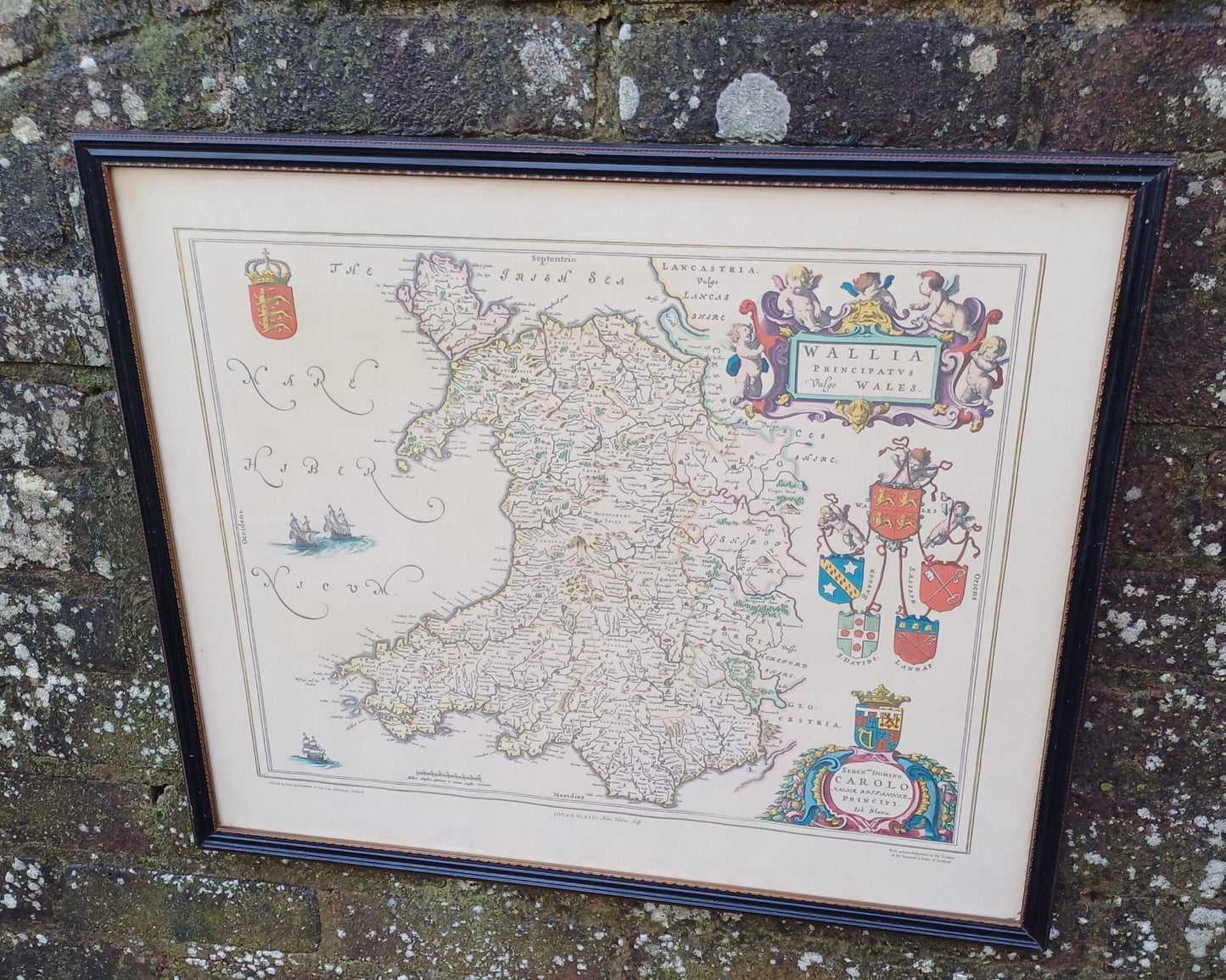 1648 depiction of Wales, Wallia, by JOhan Blaeu and printed by bartholomew. Shows all old places and names. in excellent condition. in vintage midcentury frame.