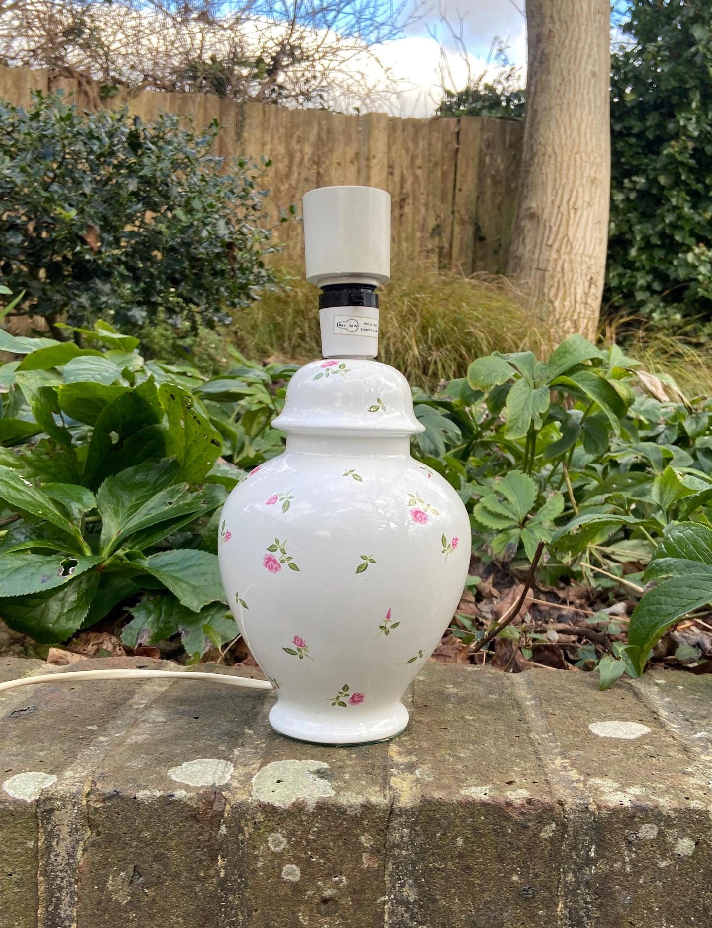 pretty white ceramic table lamp with small pink roses on it. Small attractive vintage lamp