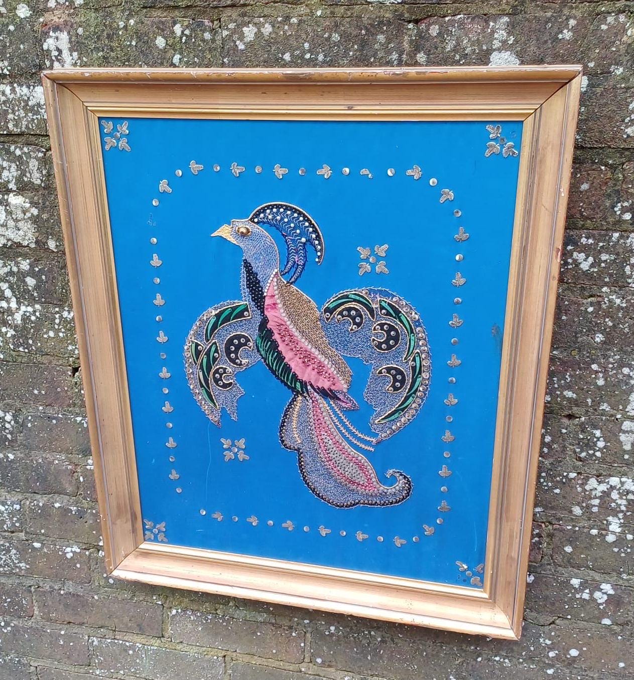 bird of paradise collage. mythical bird collage. Chakora depiction in material and embroidery. Large gold wooden frame. Bird craft work