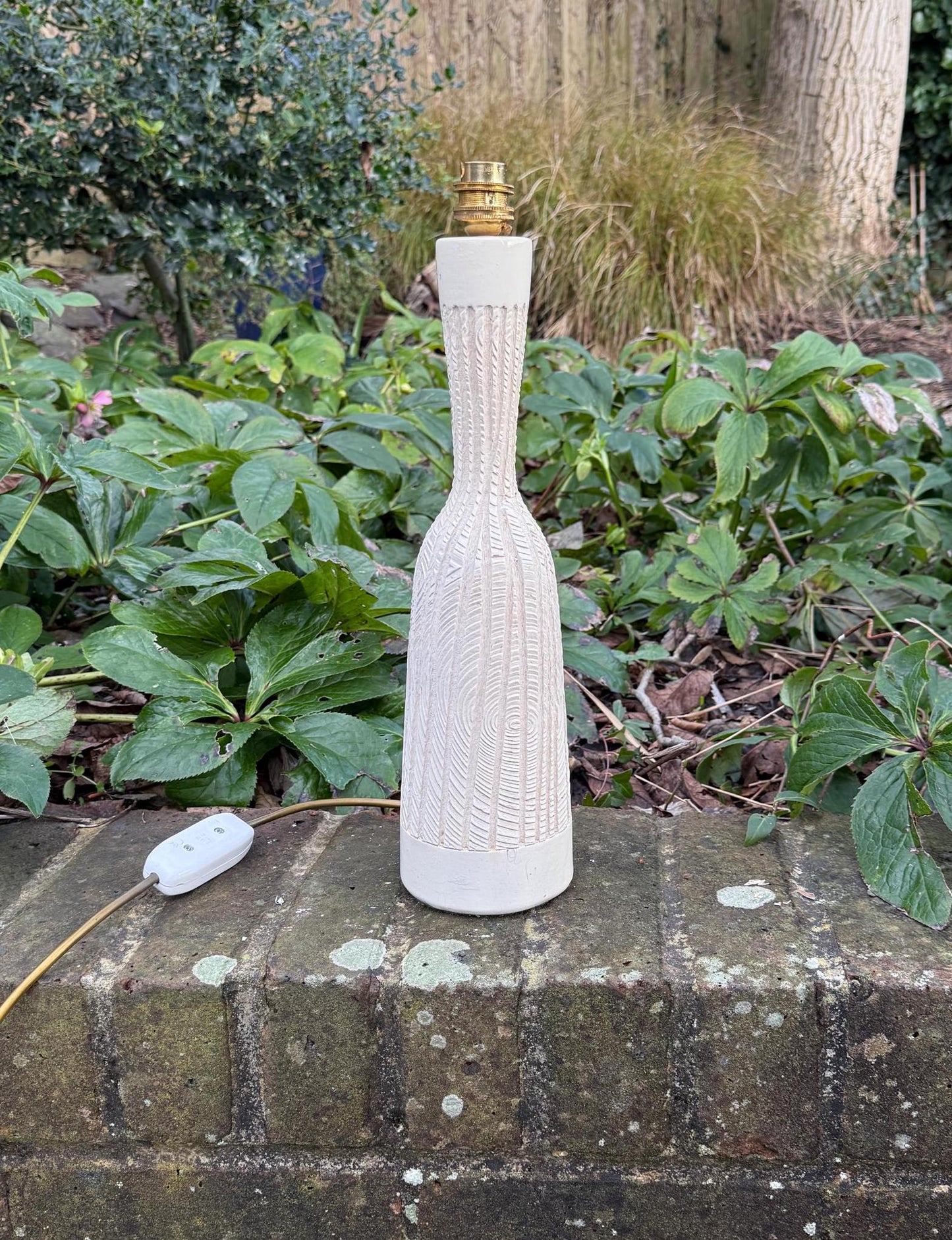 retro plaster engraved table lamp. bottle style white cream 1970s lamp.wood like pattern. working lamp.