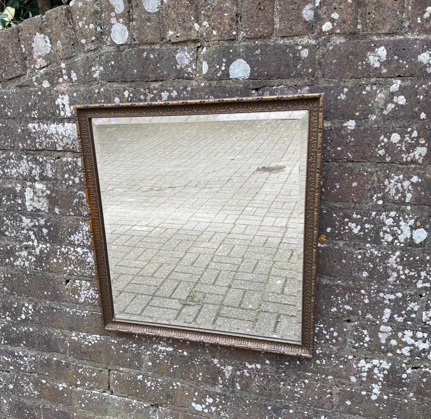1930s gesso brass coloured moulded mirror. with wooden frame. quality bevelled glass mirror.