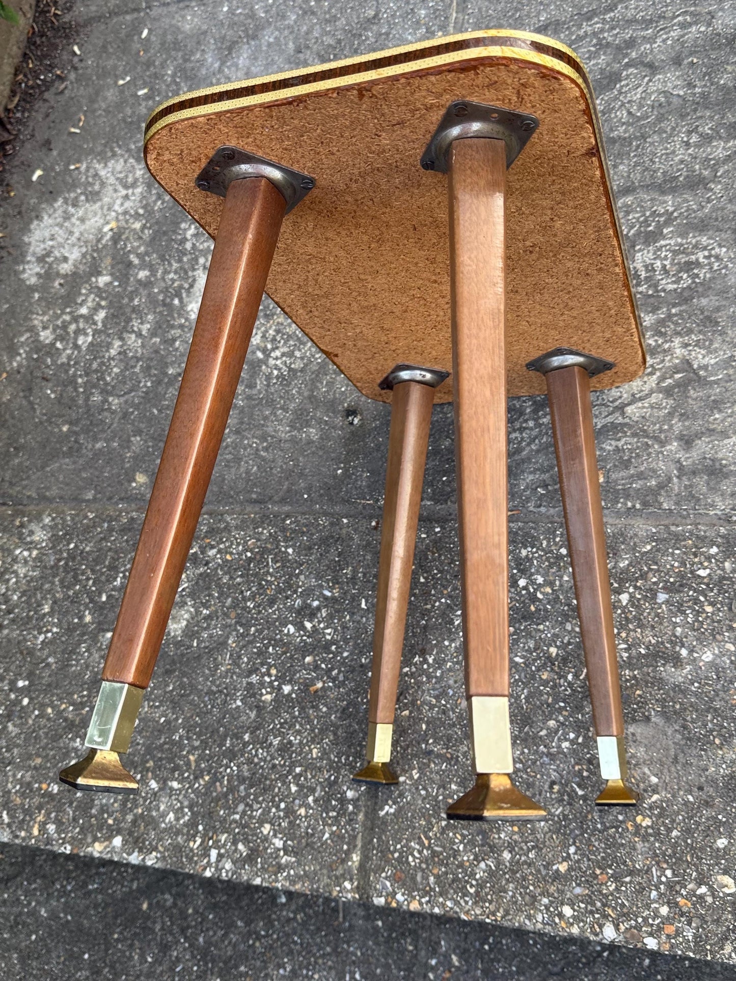 Mid-century modern small table with laminated woodgrain top, tapered legs and metal swivel capped feet