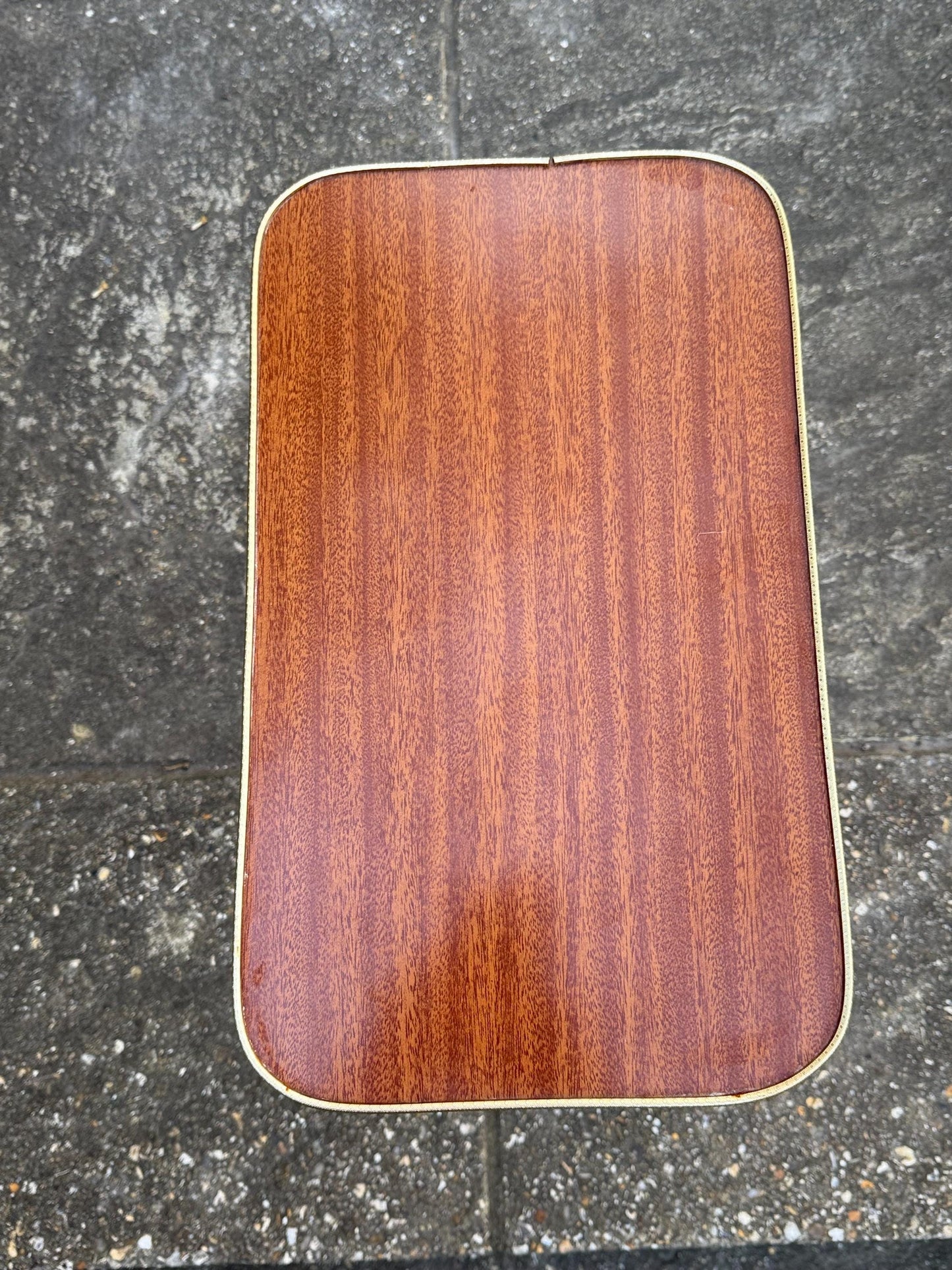 Mid-century modern small table with laminated woodgrain top, tapered legs and metal swivel capped feet