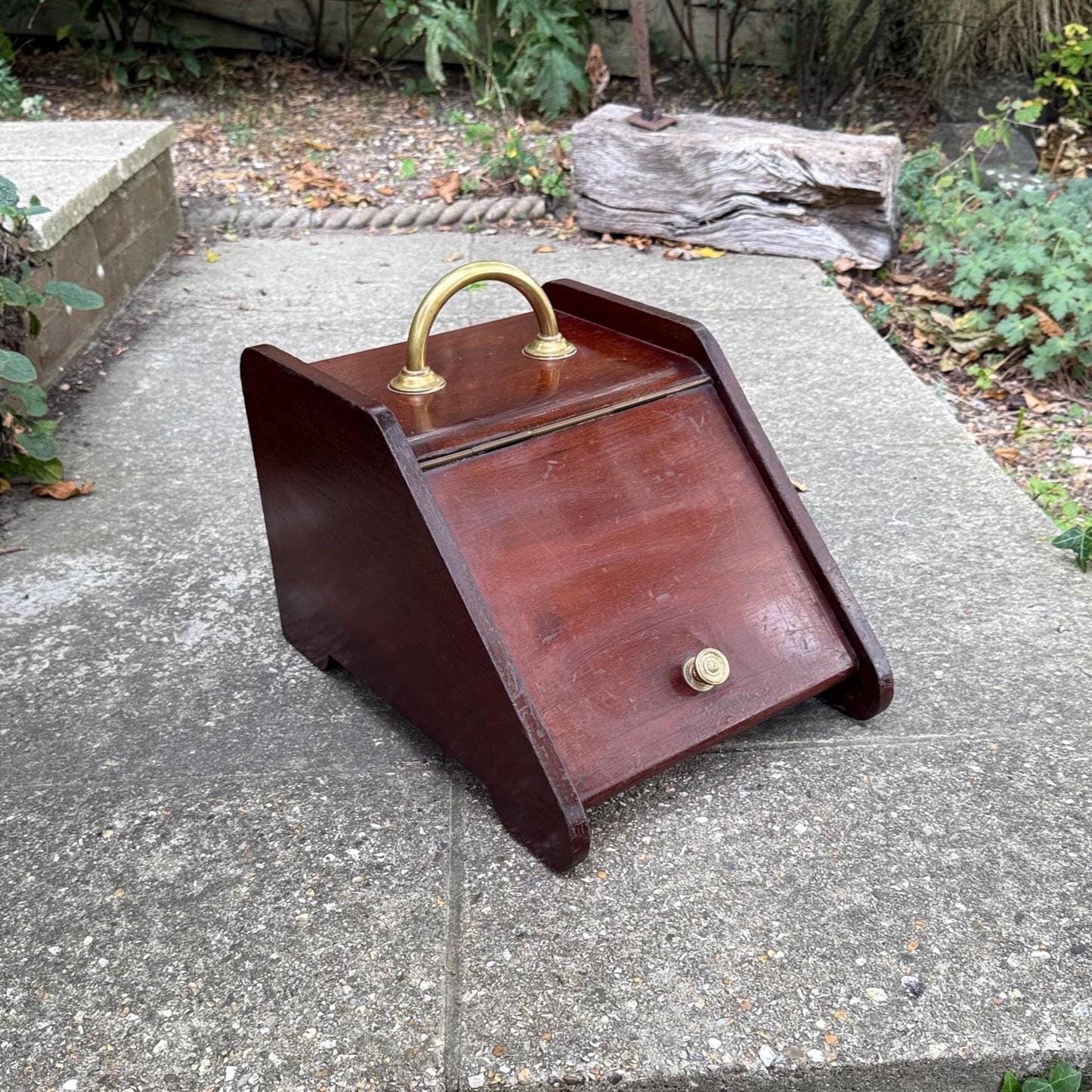 wooden mahogany coal scuttle with brass details. dark wood. handle, knob and holder for shovel. in good vintage condition