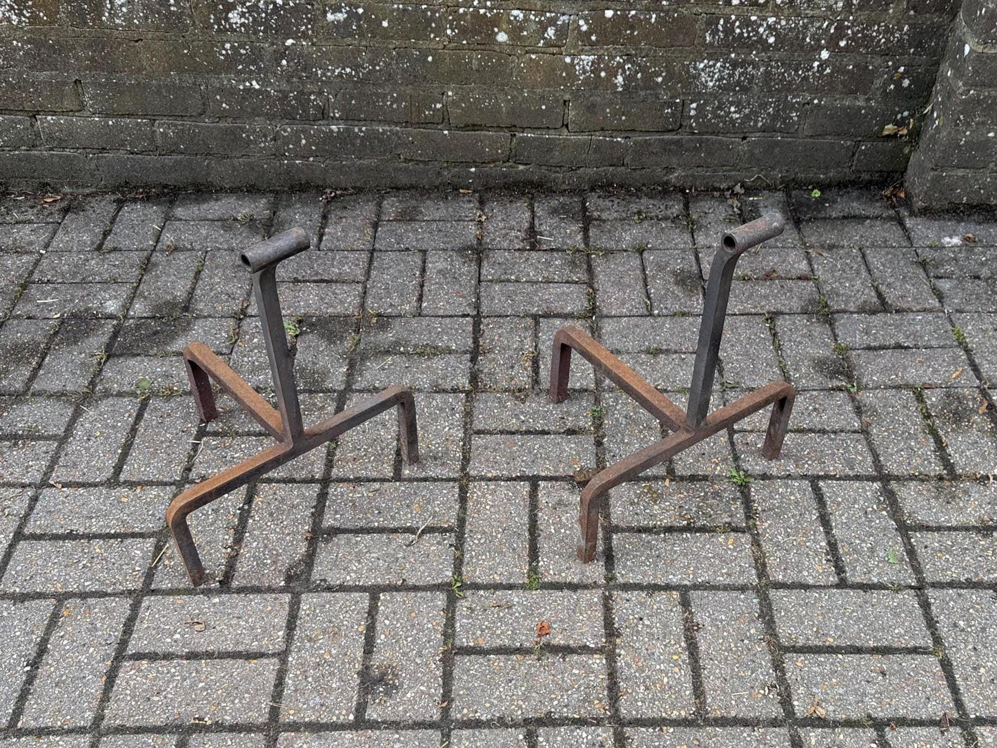 wrought iron fire dogs - unique mid century shape. rusted finish. heavy iron accessories for fireplace