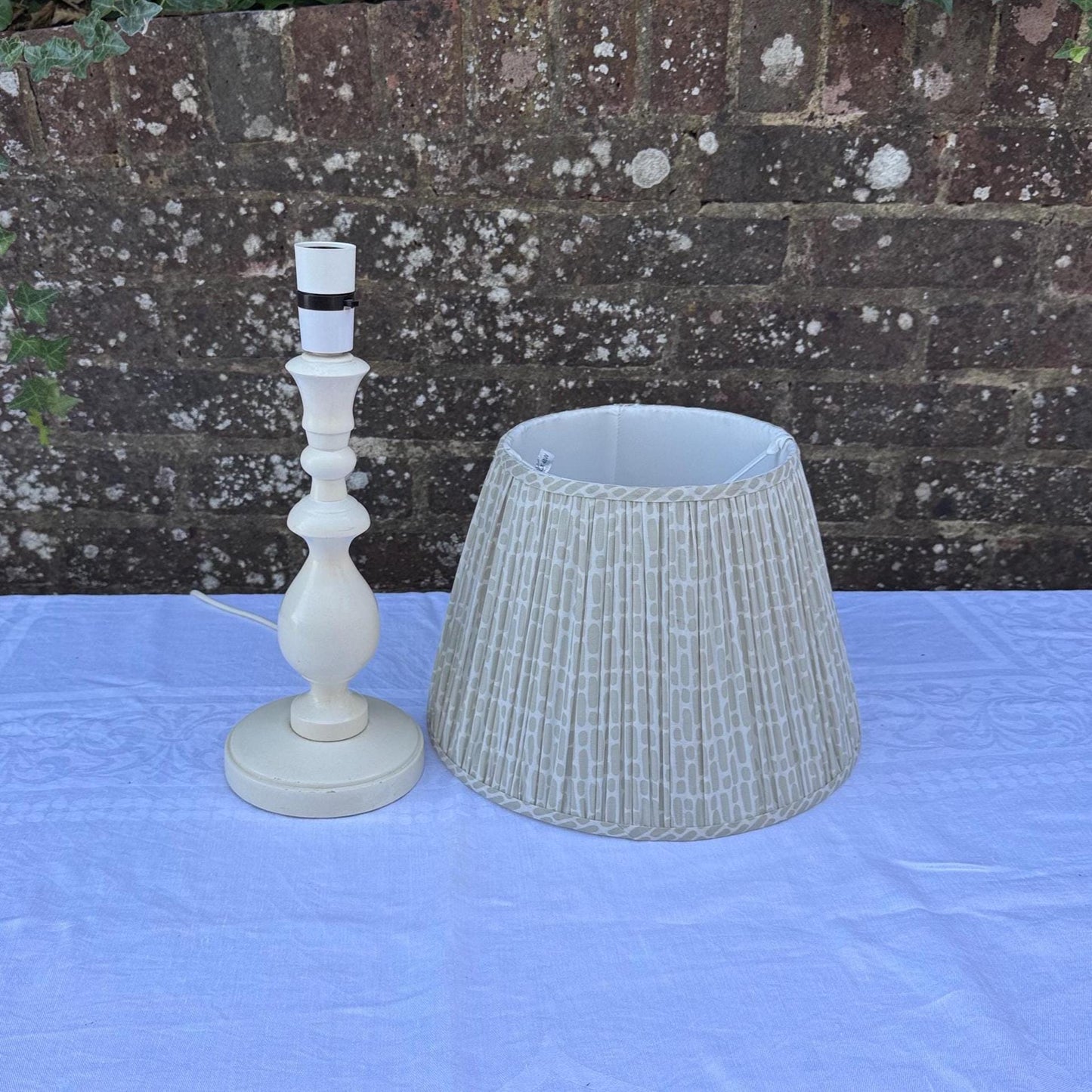 painted wooden lamp with lovely turned column and round base. comes with neutral coloured cotton lined shade with geometric pattern. clean and tidy.