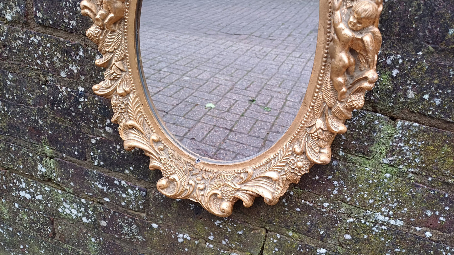 Vintage Composite Cherub Gold Gilt Decorative Mirror.