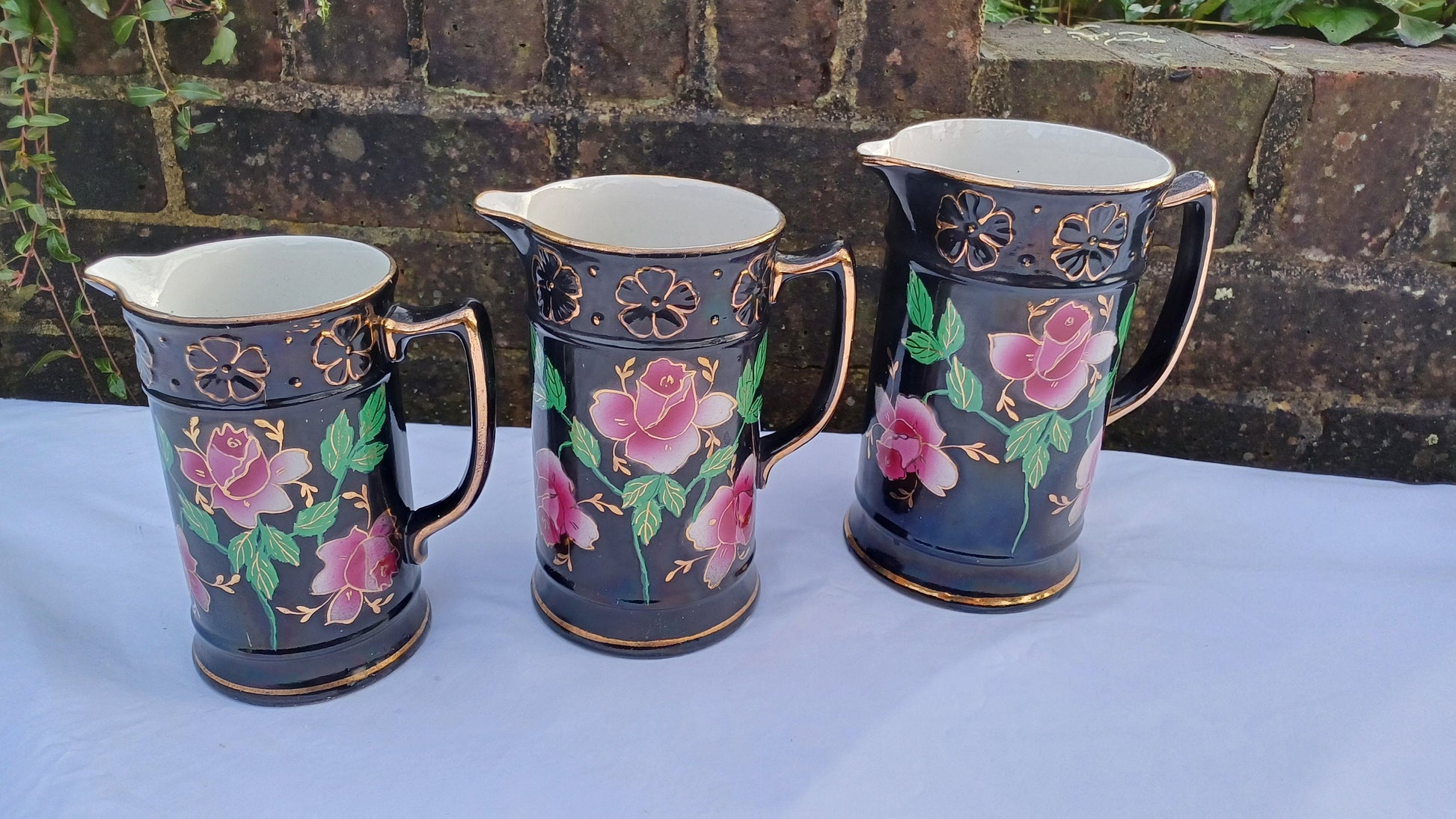 Rare Set of Vintage Victorian Graduated Jugs Black with Pink Flowers Gold Decoration.