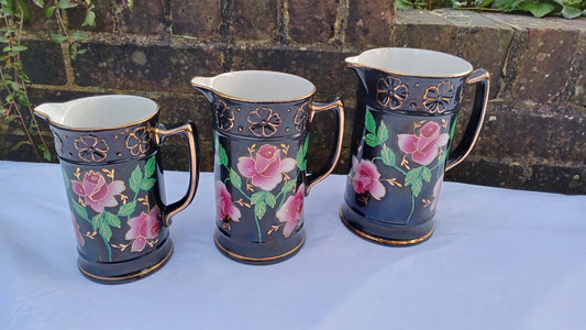 Rare Set of Vintage Victorian Graduated Jugs Black with Pink Flowers Gold Decoration.