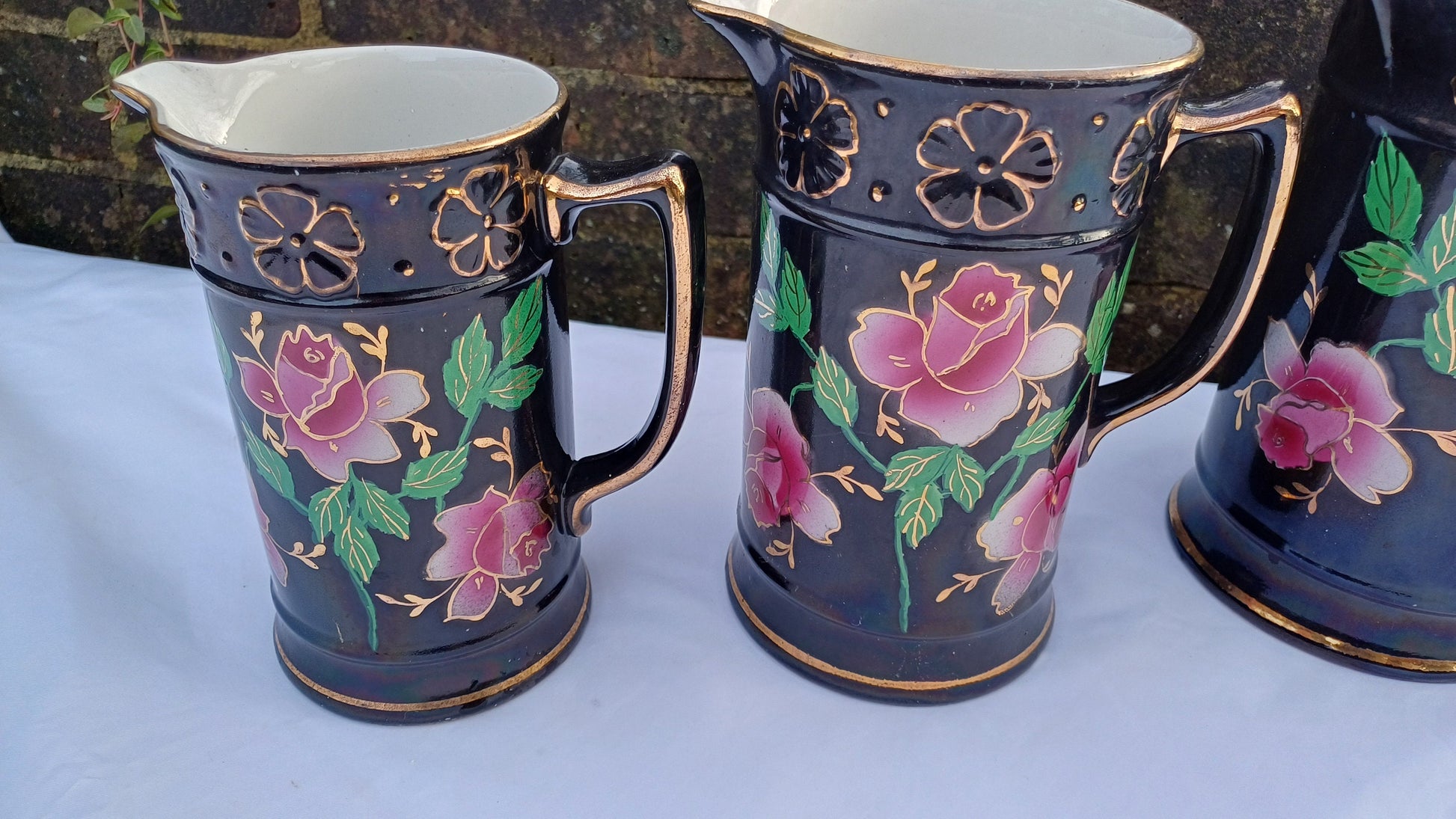 Rare Set of Vintage Victorian Graduated Jugs Black with Pink Flowers Gold Decoration.