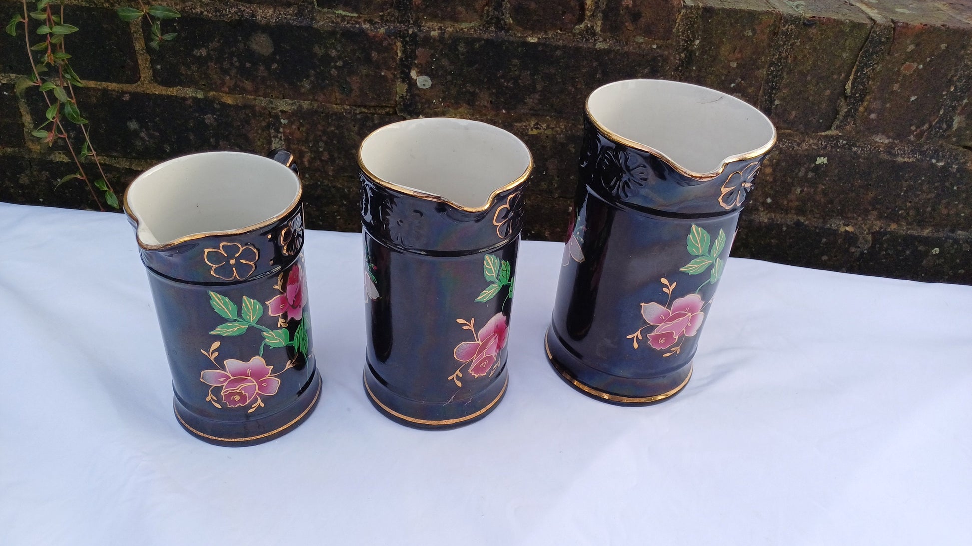 Rare Set of Vintage Victorian Graduated Jugs Black with Pink Flowers Gold Decoration.
