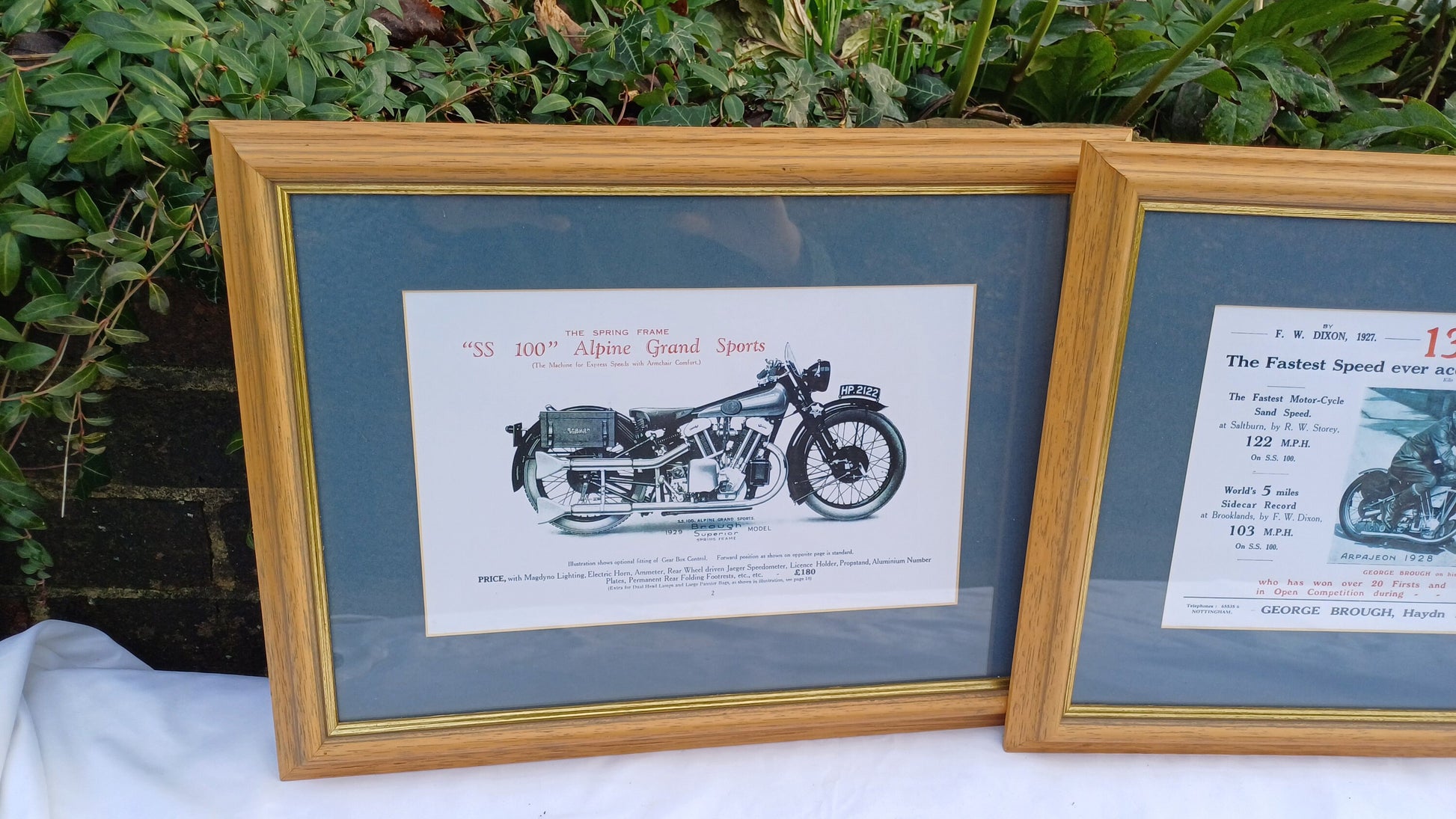 Three Vintage Motorcycle Advertising Prints 'SS100' Alpine Grand Sports and 'Pendine' George Brough with Wooden Picture Frames and Mounts.