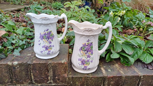 Victorian china jugs with flowers and gilt detail, two jugs matching