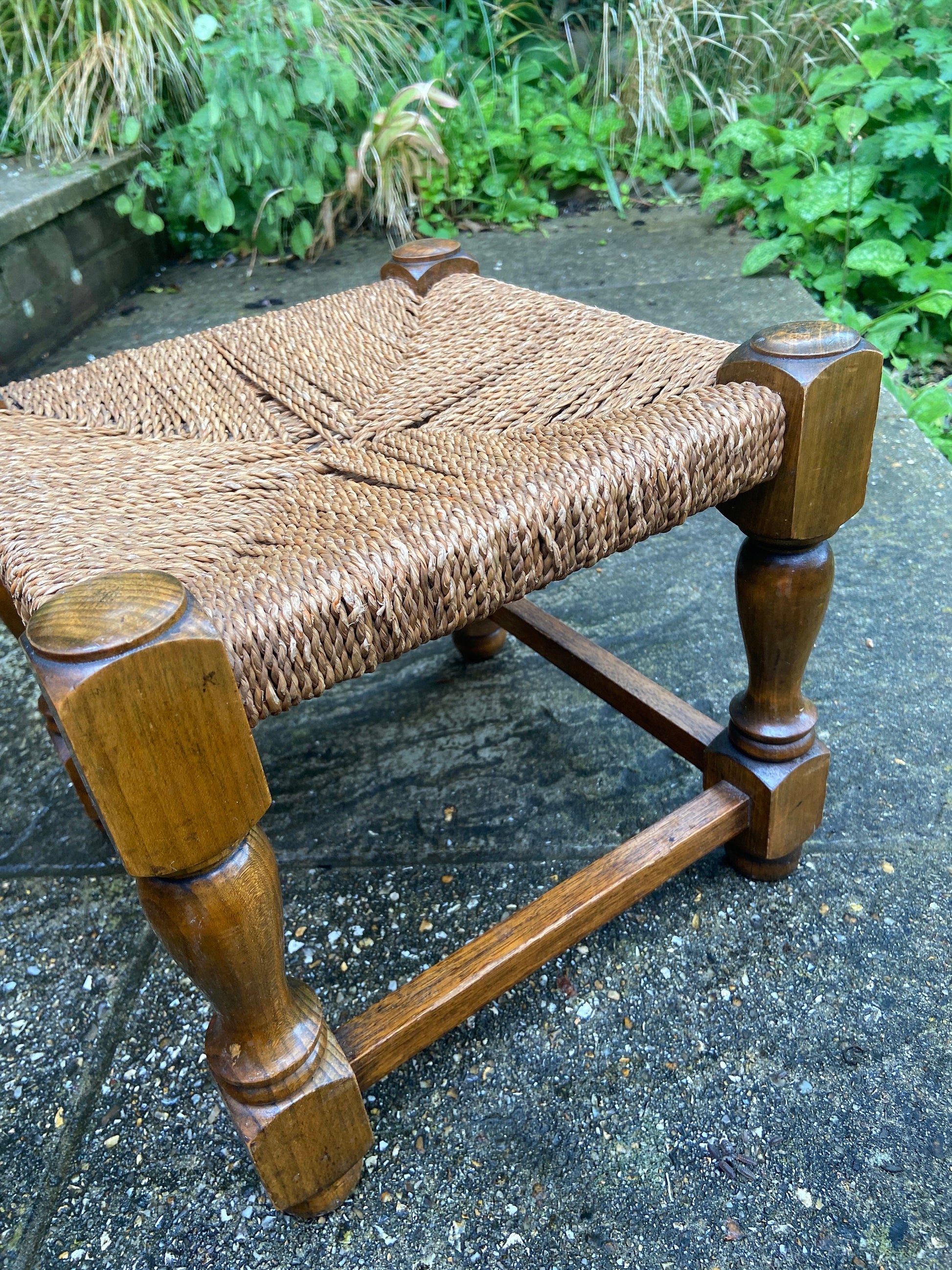 Early twentieth century vintage foot stool, wooden frame with string woven seat, authentic old stool, child stool