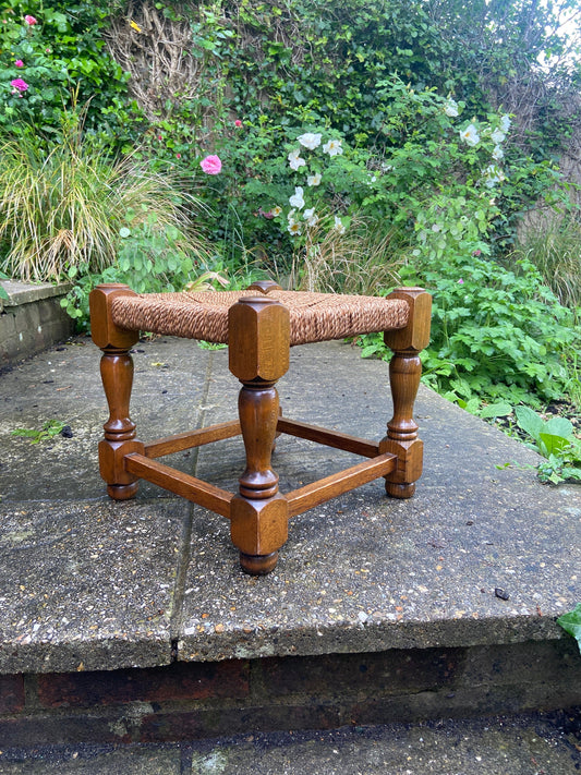 Early twentieth century vintage foot stool, wooden frame with string woven seat, authentic old stool, child stool