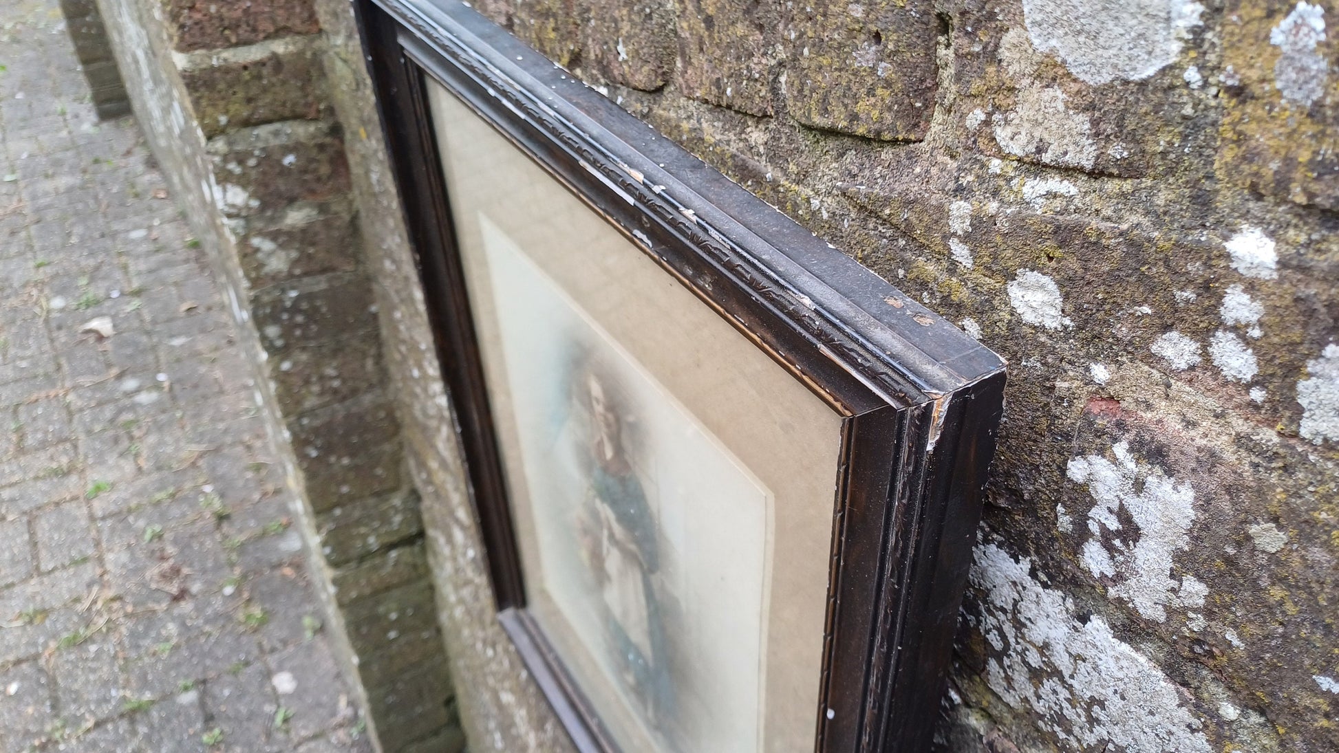 Vintage photo sepia of young woman, in dark wood vintage glazed frame