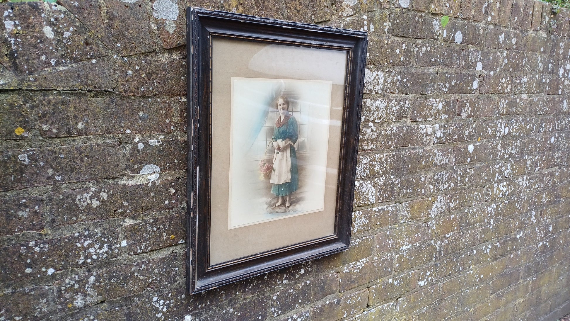 Vintage photo sepia of young woman, in dark wood vintage glazed frame