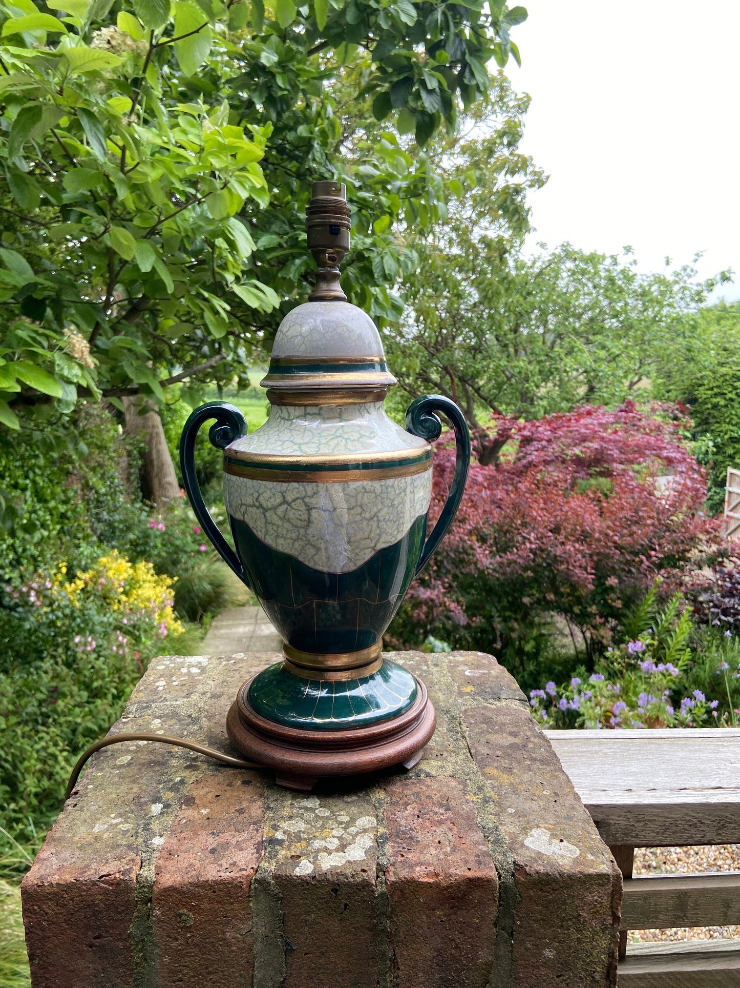 gold and green working table lamp; vintage lamp in urn style with handles, classical shape;on a wooden base; with mottled and marble effect glaze