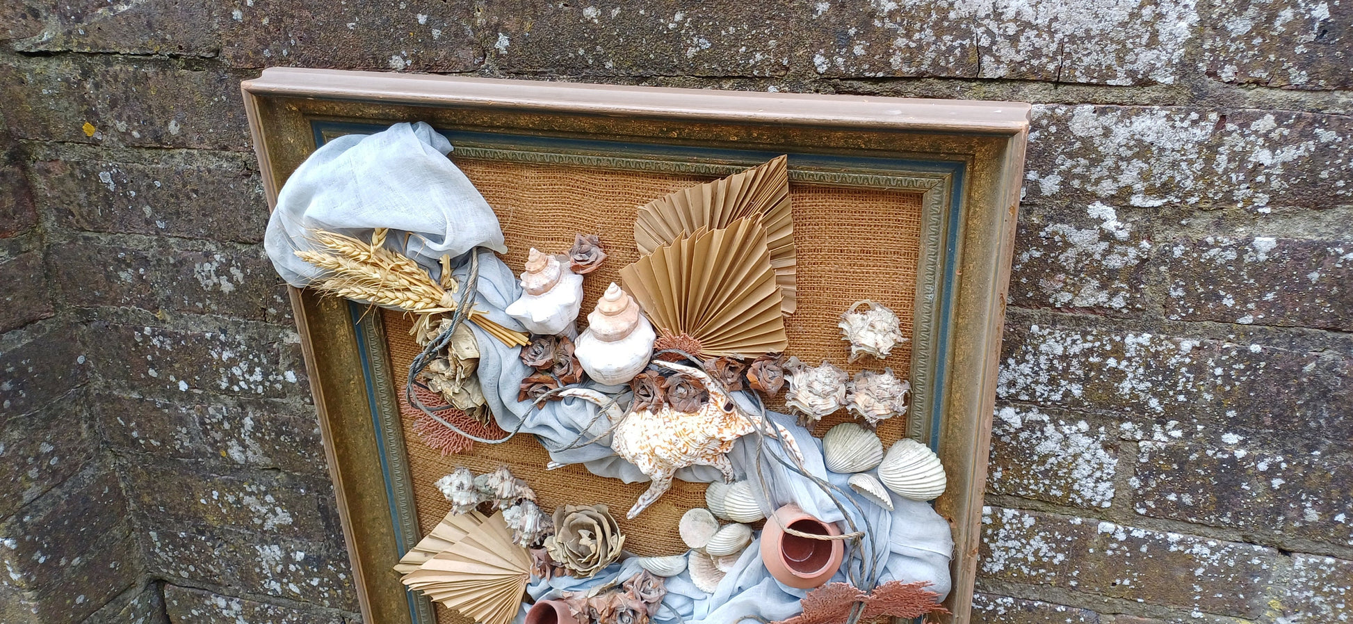 Stunning piece of 3D craft/ collage - real shells, coral, material, plants all displayed on a hessian backing in a upcycled vintage frame