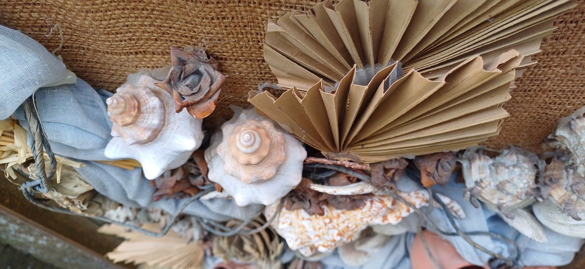 Stunning piece of 3D craft/ collage - real shells, coral, material, plants all displayed on a hessian backing in a upcycled vintage frame