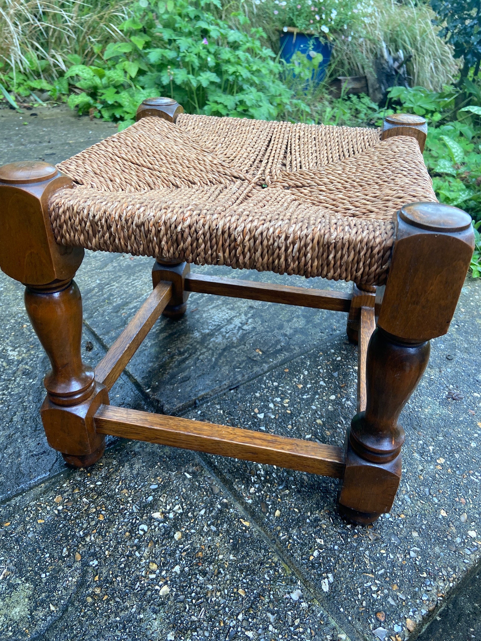 Early twentieth century vintage foot stool, wooden frame with string woven seat, authentic old stool, child stool