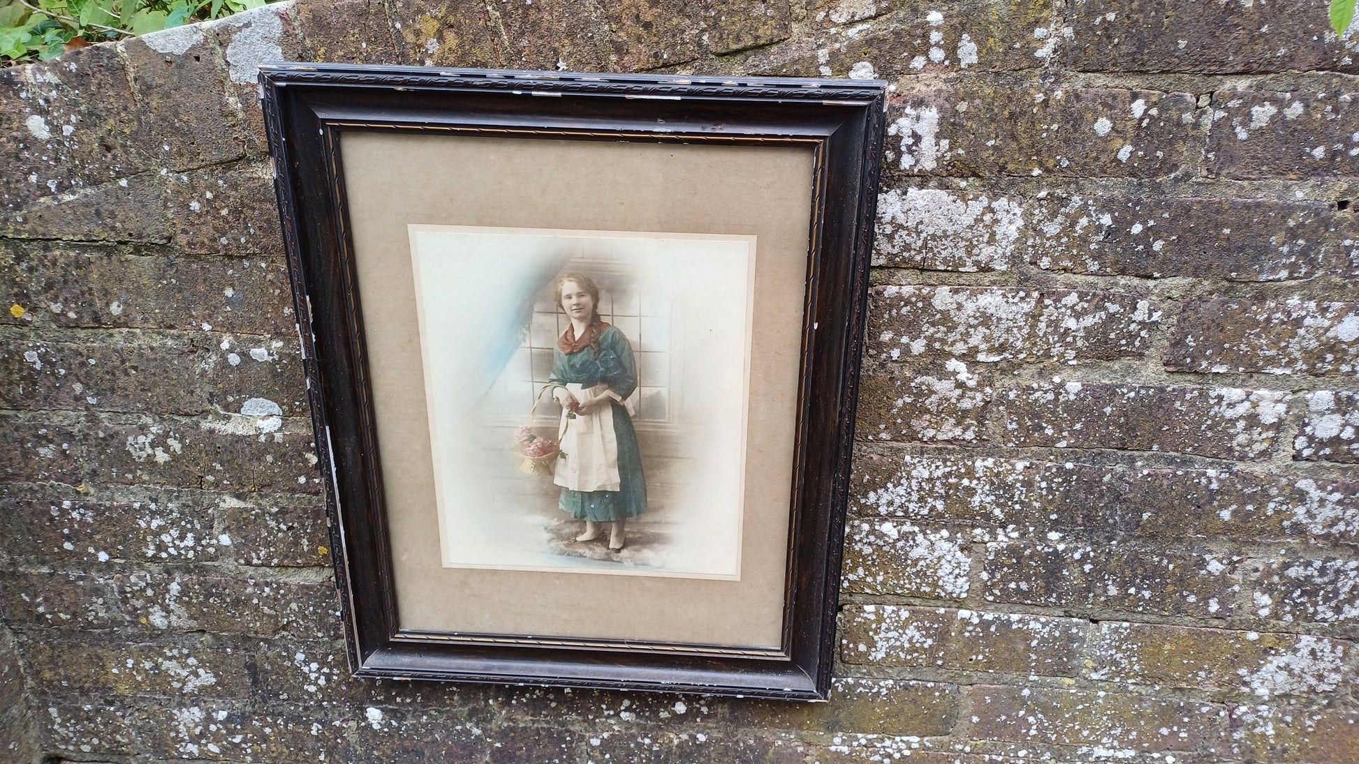 Vintage photo sepia of young woman, in dark wood vintage glazed frame